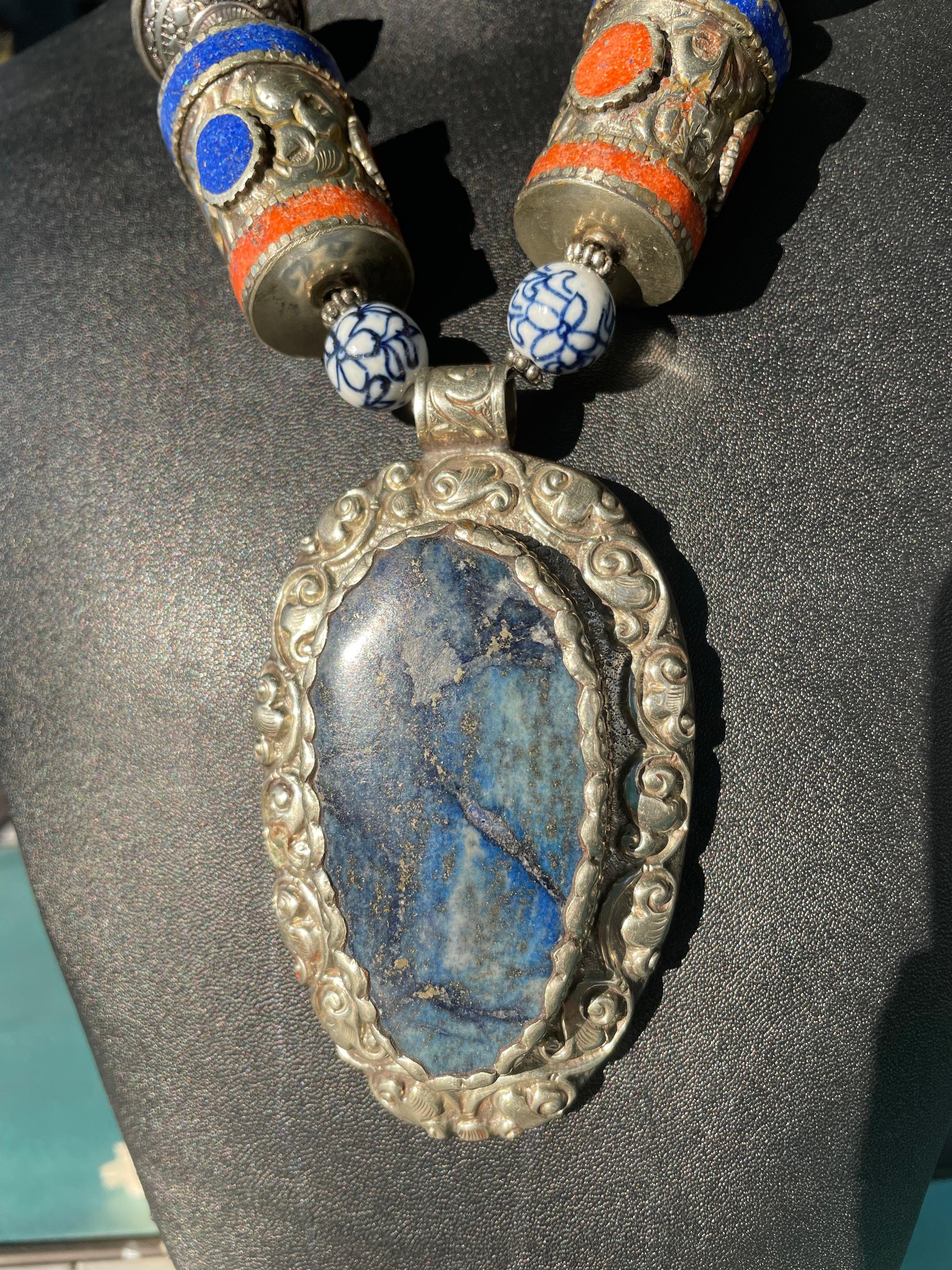 Lorraine’s Bijoux offers a one of a kind,handmade,statement Ethnic necklace.The Tibetan lapis and silver pendant is eye catching and formidable. It hangs on a strand of large Moroccan inlay beads; quartz crystal,Chinese  ceramic,Tibetan silver and