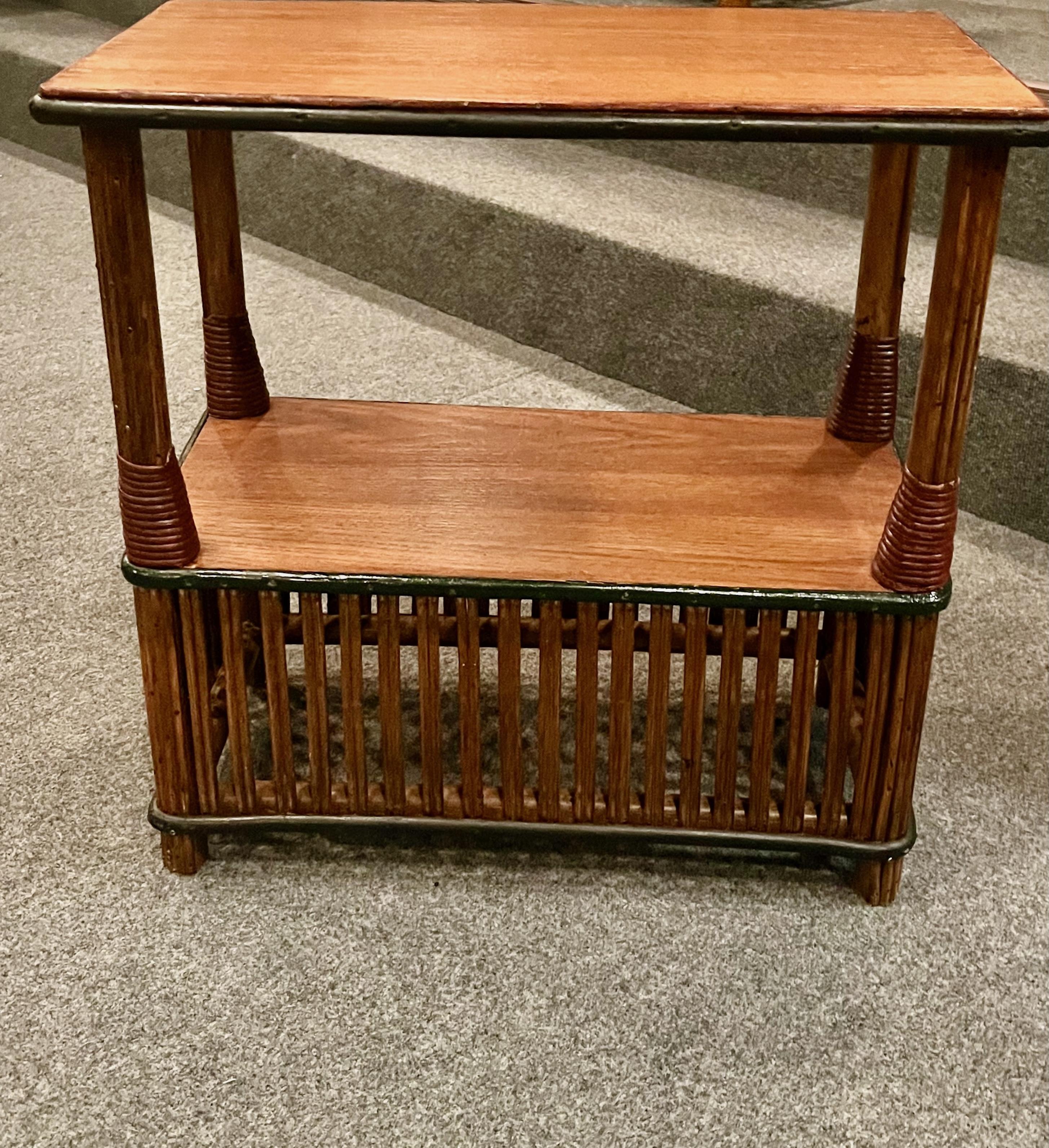 This is one of pair of matching antique rattan side tables, American, C. 1929 attributed to the Heywood Wakefield Company of Gardner Massachusetts that are in very good condition with quarter sawn oak top and bottom surfaces that have been