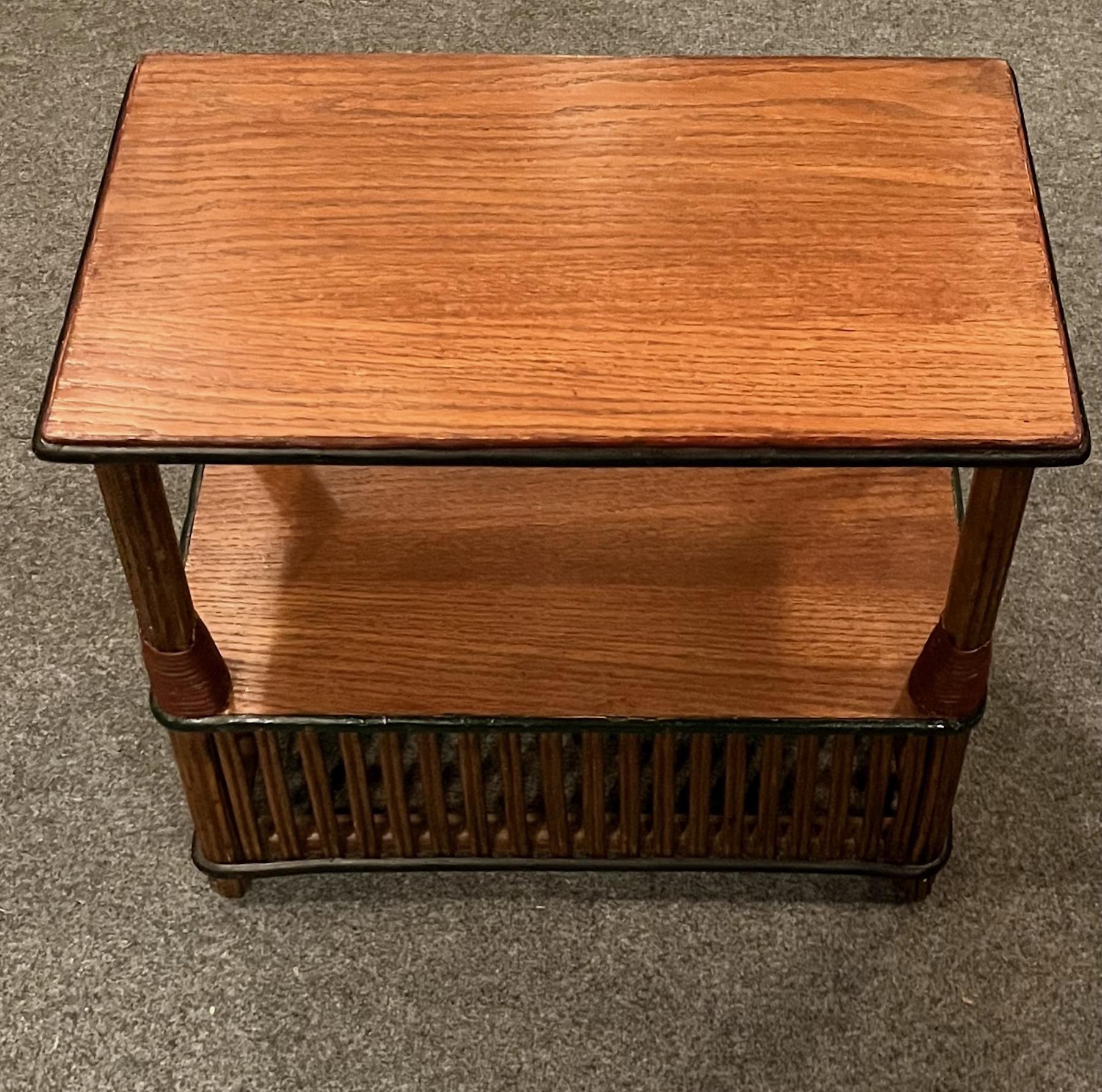 This is one of pair of matching antique rattan side tables, American, C. 1929 attributed to the Heywood Wakefield Company of Gardner Massachusetts that are in very good condition with quarter sawn oak top and bottom surfaces that have been
