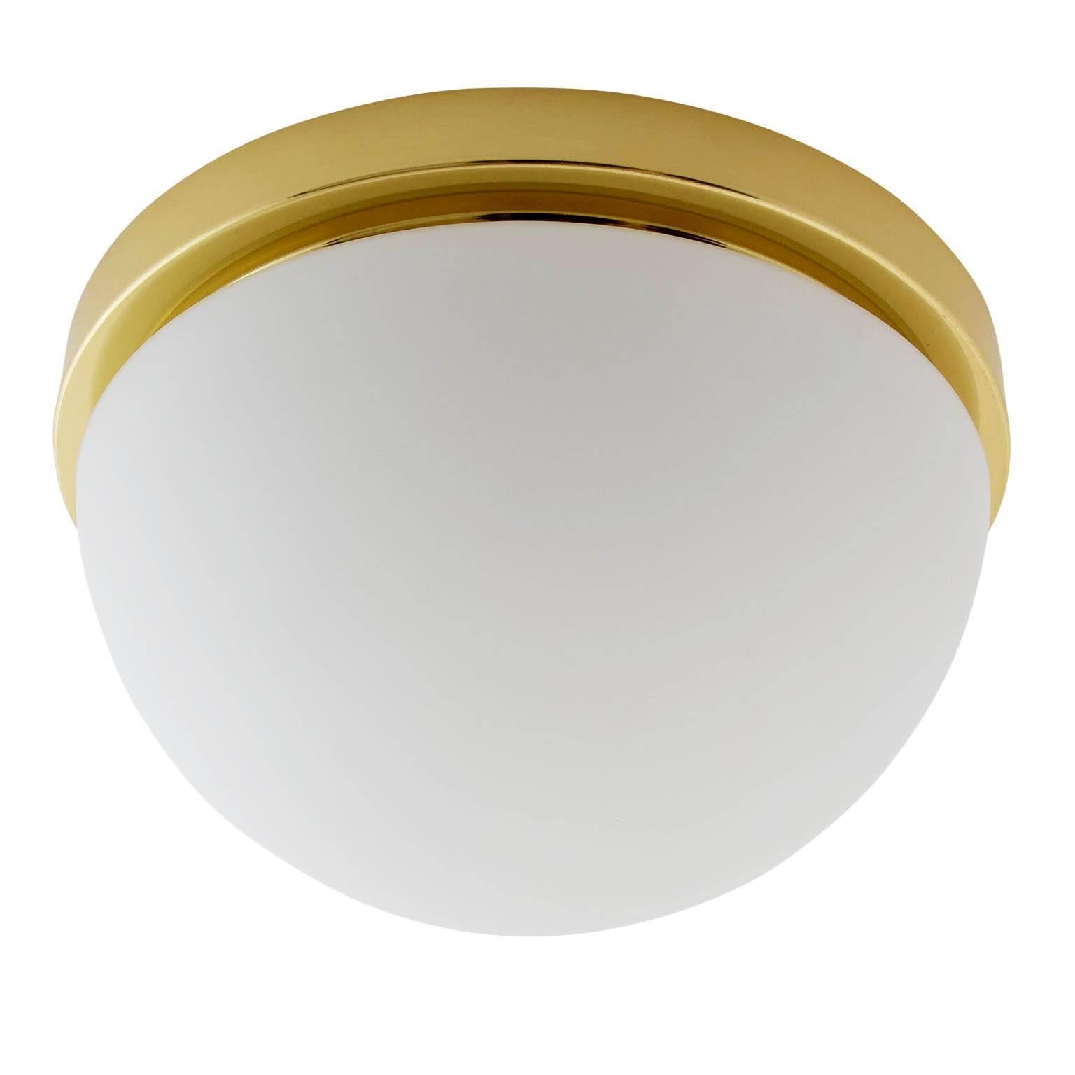 One of eight flush mount or wall lights by Glashütte Limburg, manufactured in midcentury, circa 1970.
They are made of a polished brass armature with a dome shaped opal glass lampshade. Labelled with Glashütte Limburg.
The price is per light. They