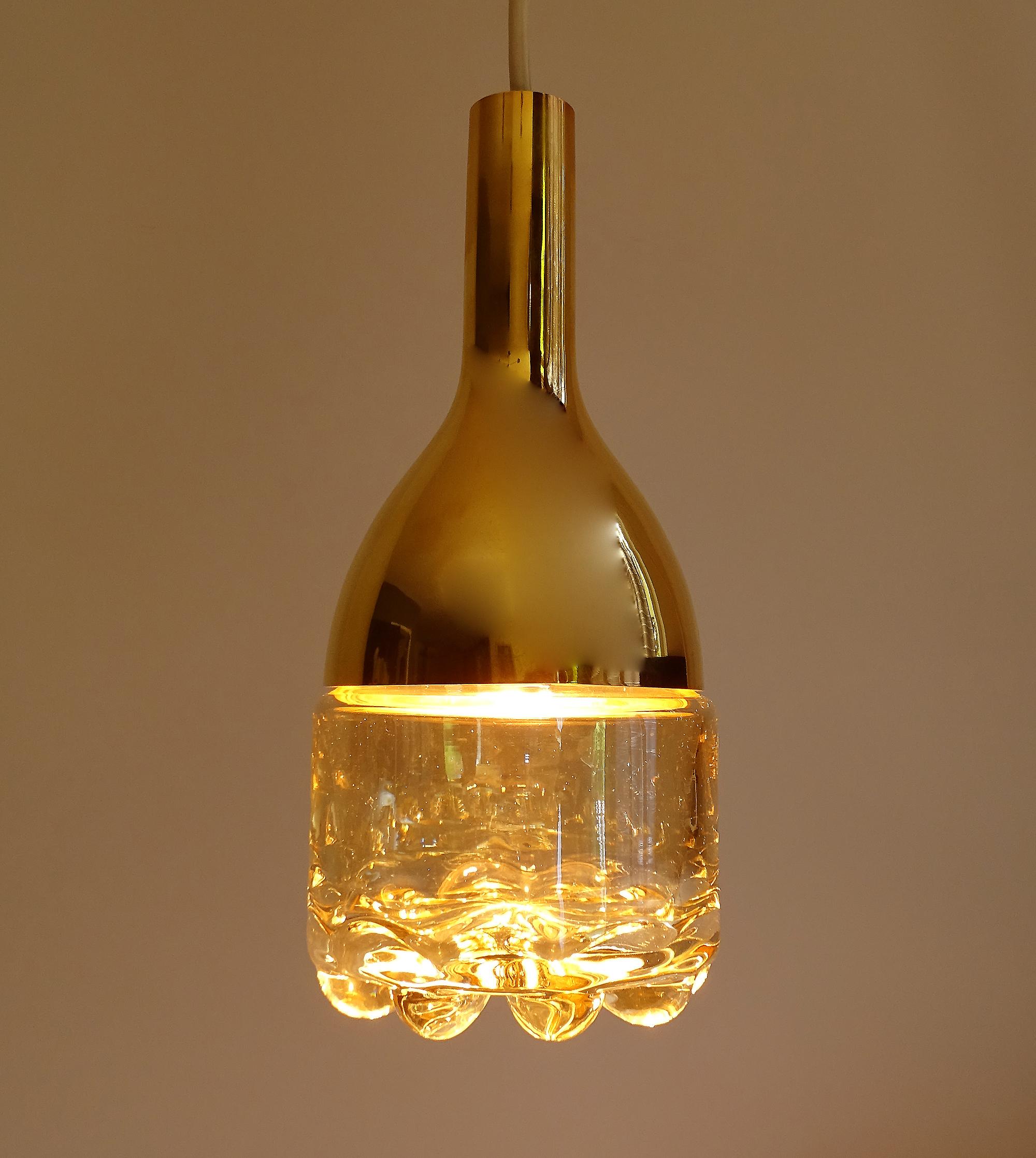 One of five pendant lights by Limburg featuring tumbler style blown glass shades with a spike pattern at the bottom, brass 