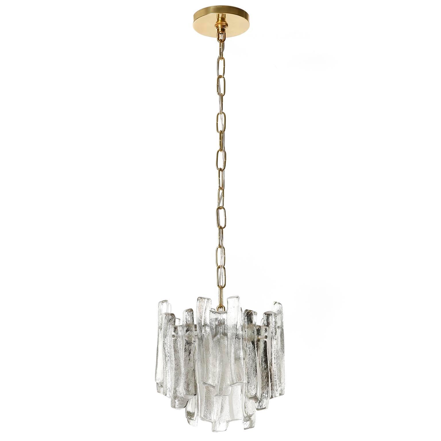 One of five beautiful ice glass pendant light fixtures by Kalmar, Austria, manufactured in midcentury, circa 1970 (late 1960s or early 1970s). Each lamp is made of 12 cast ice glass blocks which are mounted on a silver painted metal frame. The cast