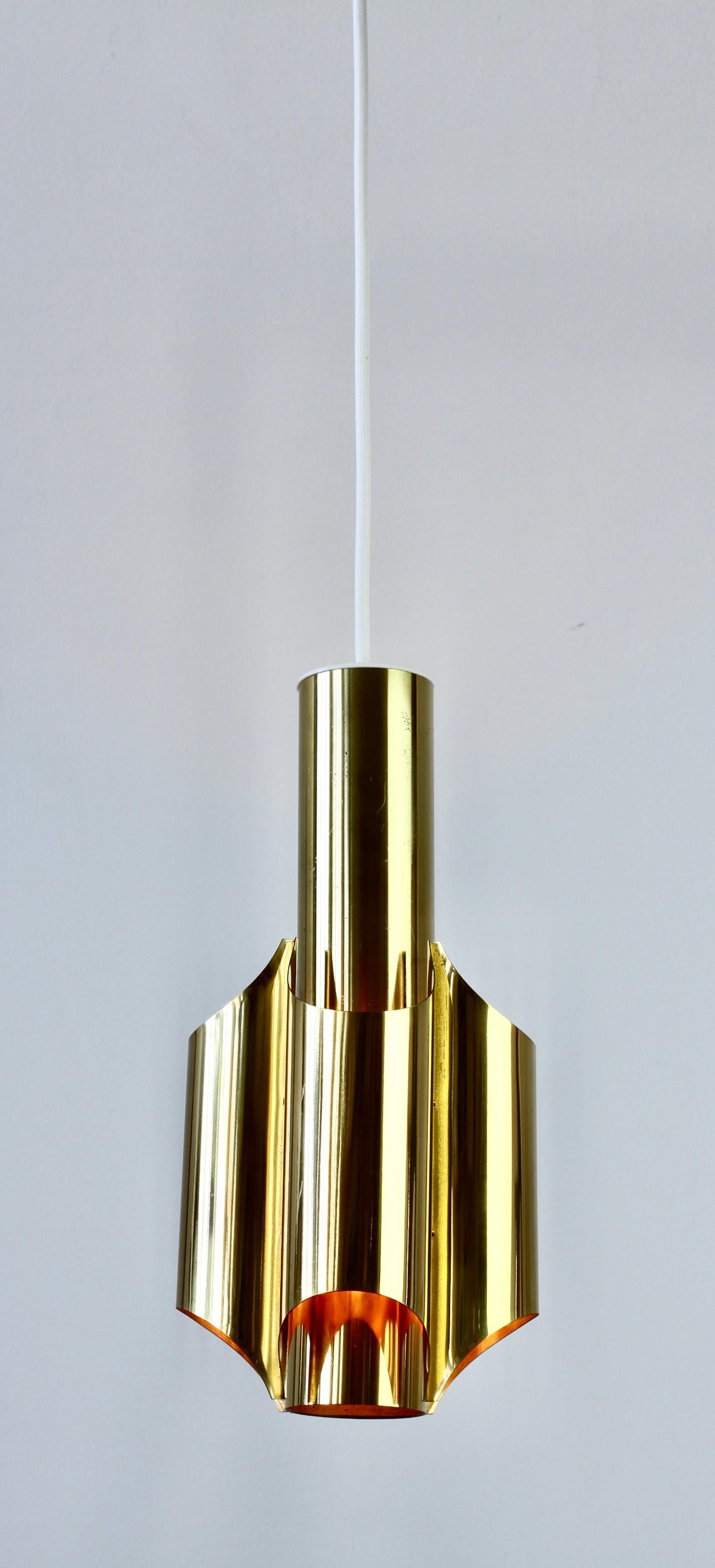 A single rare and unusual futuristic polished brass European pendant light fixture in a similar style to the 'Fuga' wall lights by Dutch firm RAAK of Amsterdam and the 'orgues' luminaires by French design house Maison Charles, circa 1970s. The