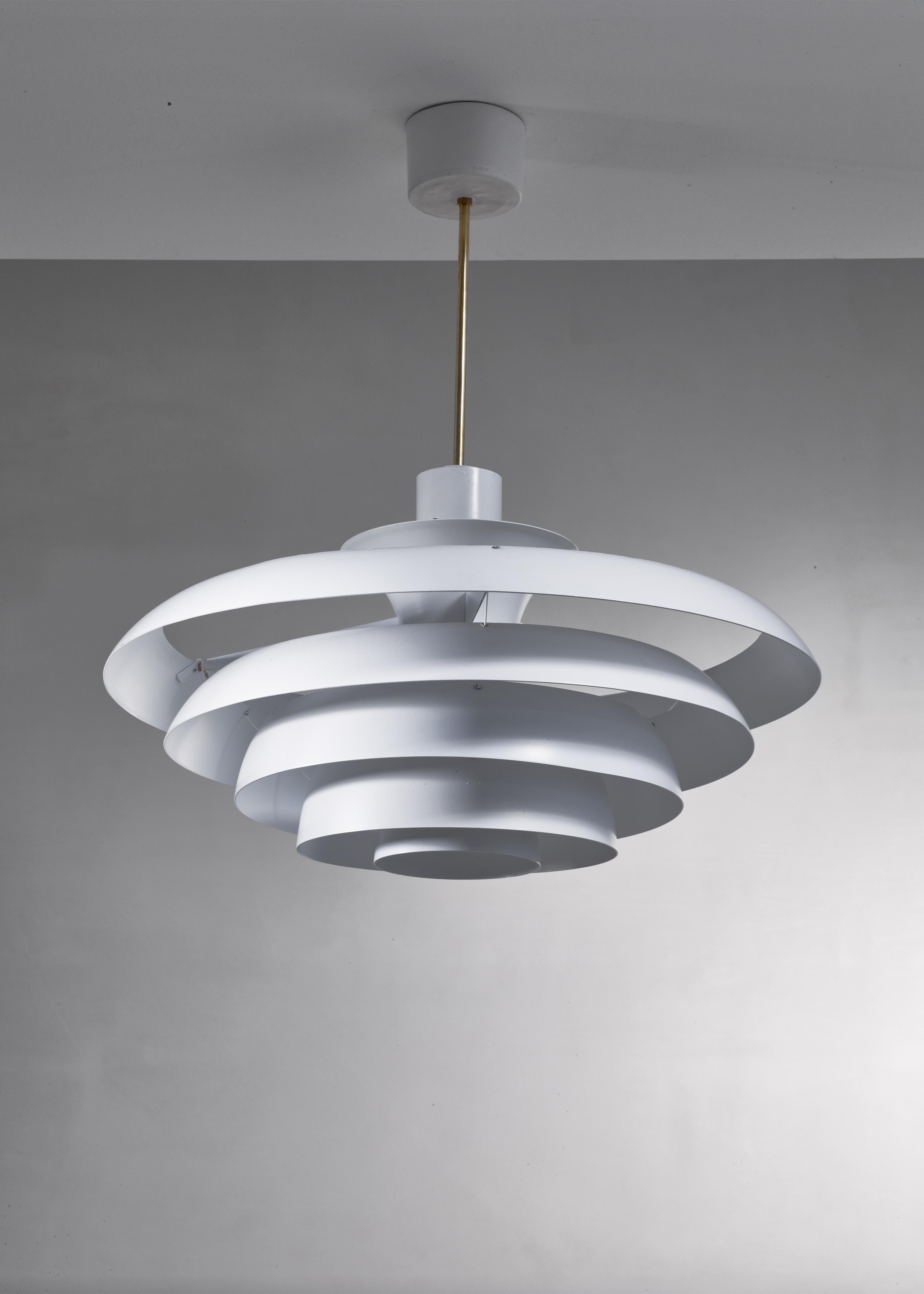 A Fagerhults pendant lamp made of five white lacquered concentric rings of metal, hanging from a brass stem.

The measurements stated are of the shade. On request, the drop can be adjusted to your requirements. 


Available per piece. Total of