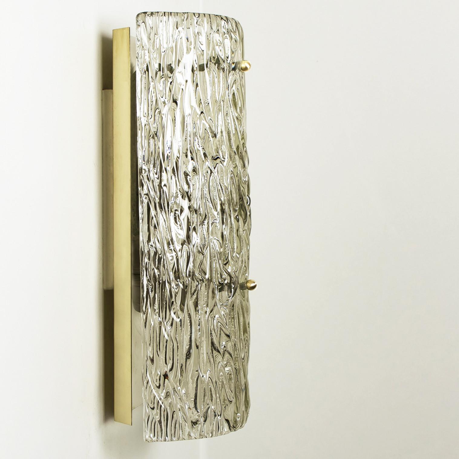 One of the four high-ended structured glass wall sconces by Kalmar, designed by J.T. Kalmar and produced by Kalmar Franken, Austria, manufactured in circa 1970, (late 1960s and early 1970s). The frame is made from brass and holds brass pins and