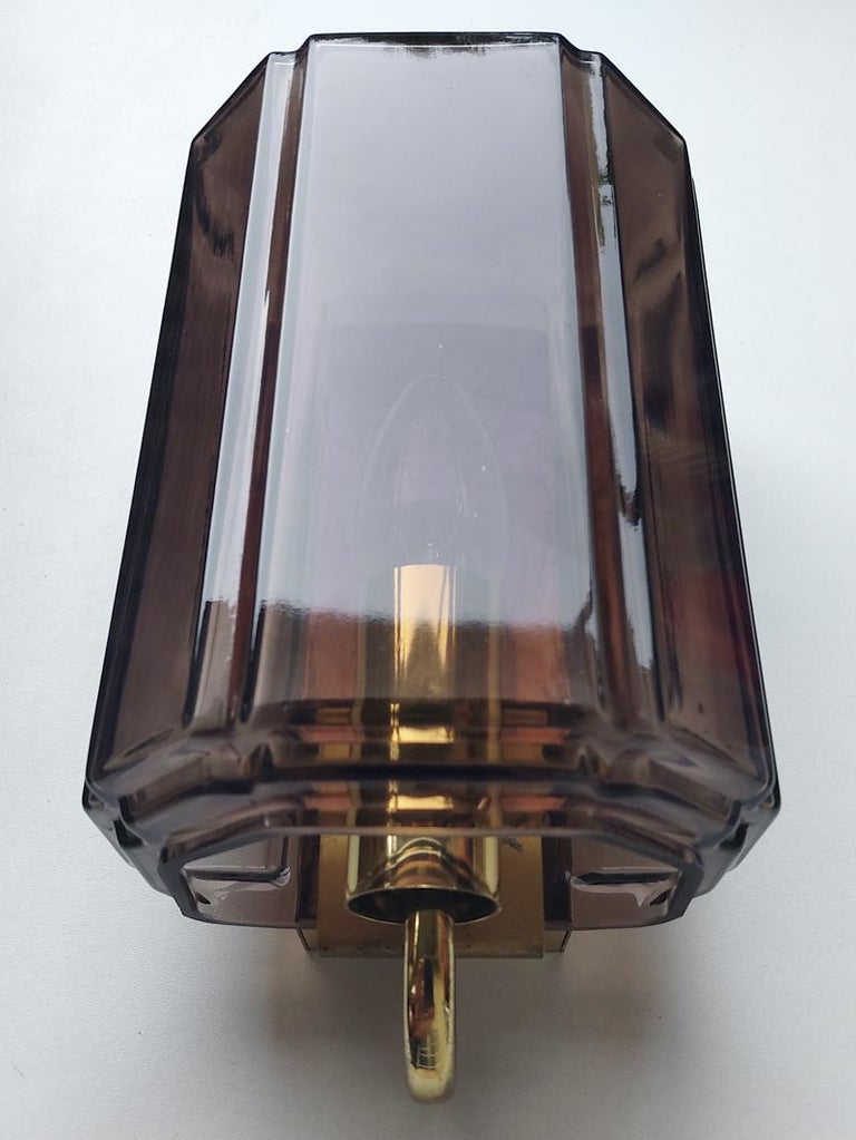 One of blown brown glass and brass sconce. 
Germany, 1960s.
 