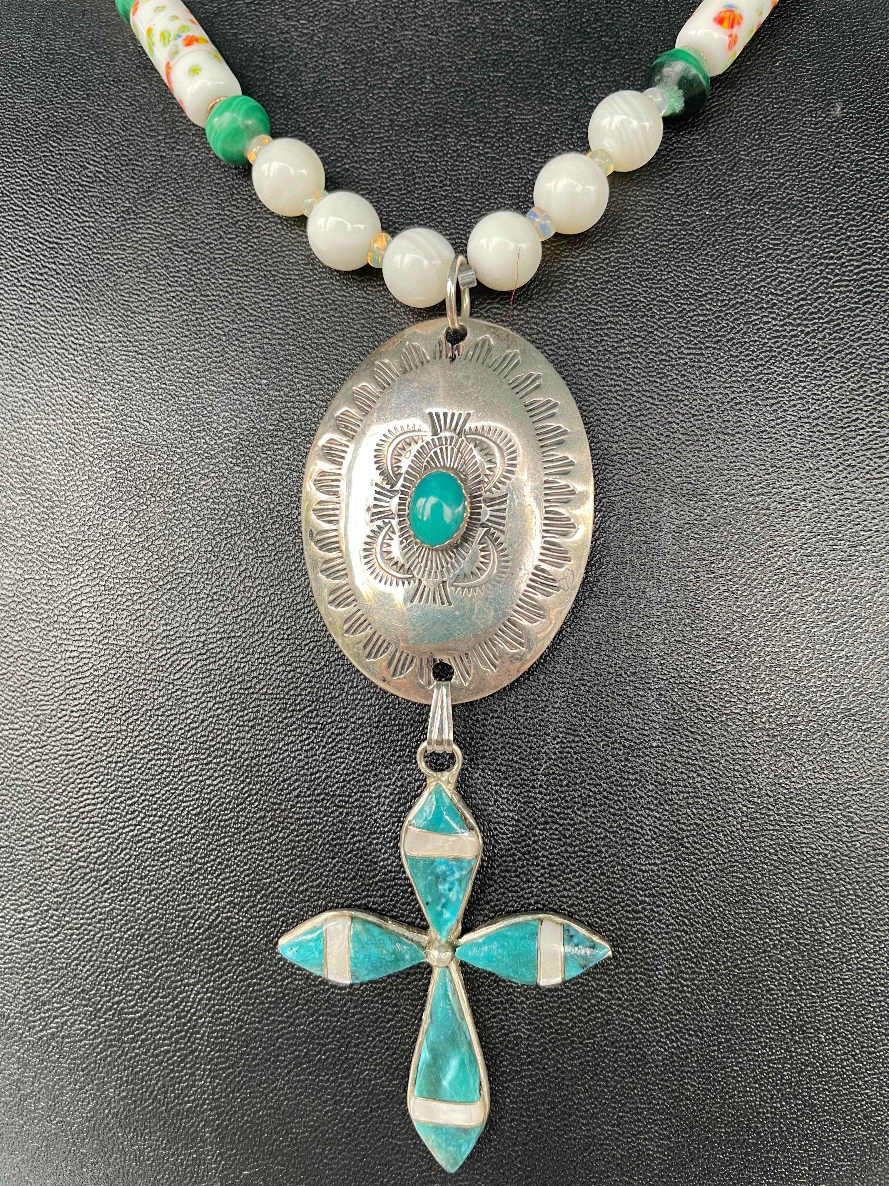 One of a kind,handmade,statement necklace is on offer from Lorraine’s Bijoux. Mother of pearl,malachite,sterling silver ,vintage concha brooch and vintage artisan cross comprise the pendant.Vintage mother of pearl,malachite beads,and vintage