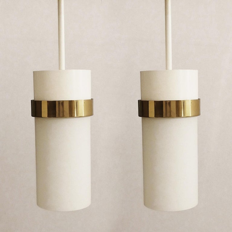 One of ... gorgeous blown white matte glass, metal and brass pendant light.
Italy, 1960s

Body: Height 12 in, diameter 5.1 in
Lamp sockets: 1x E27 (US E26).

   