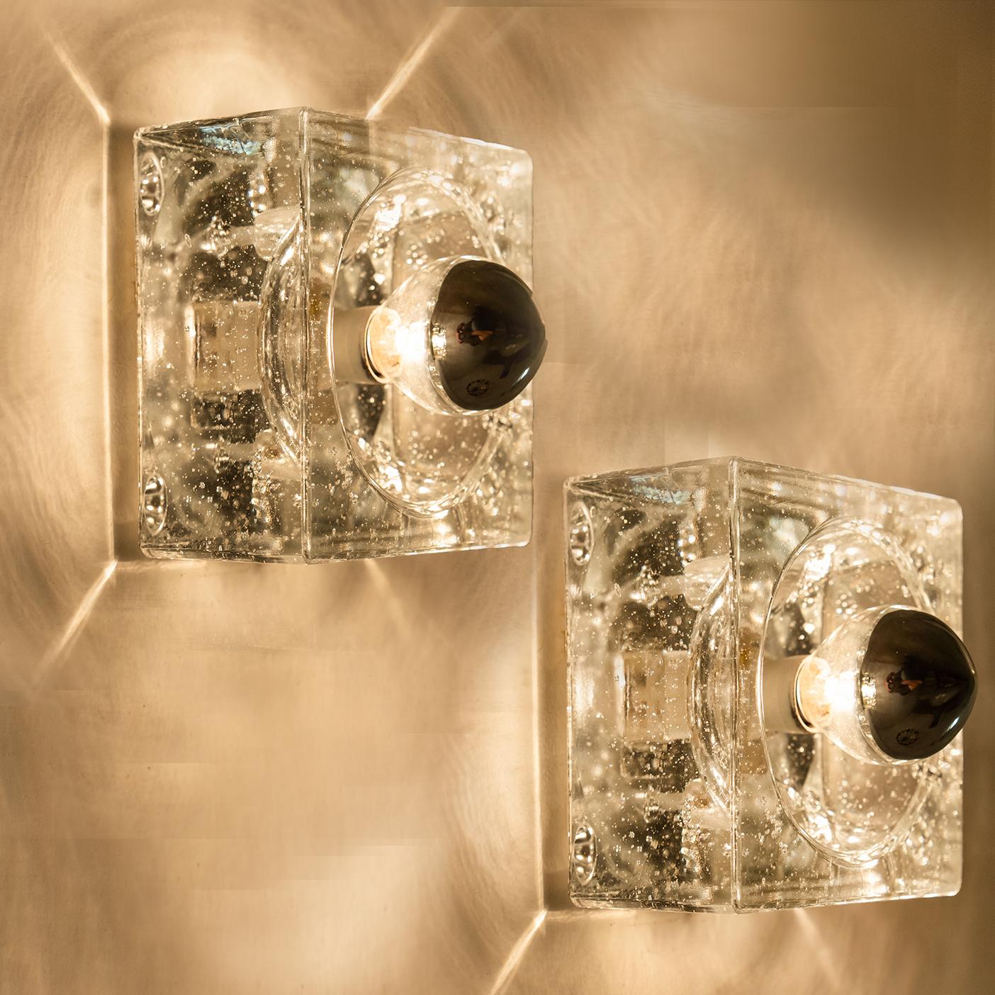 This lights are made from thick hand blown glass on a square silver colored backplate. The glass causes a nice lighting effect on the ceiling, table or wall. Each lamp has an E14 fitting (max 25 watt) and it is possible to have a (pull) switch.