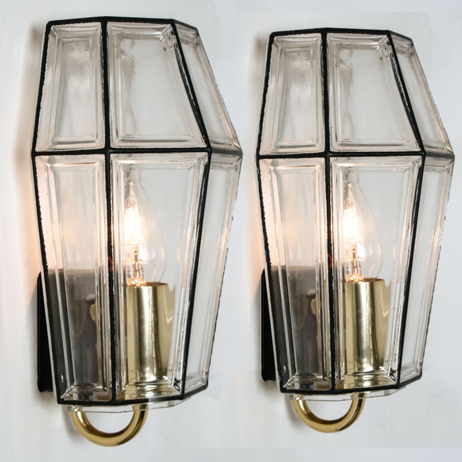 This beautiful and unique set of hand blown glass wall lights were manufactured by Glashütte Limburg in Germany during the 1960s (late 1960s-early 1970s). Beautiful craftsmanship. These midcentury vintage lights feature handmade, elaborate clear