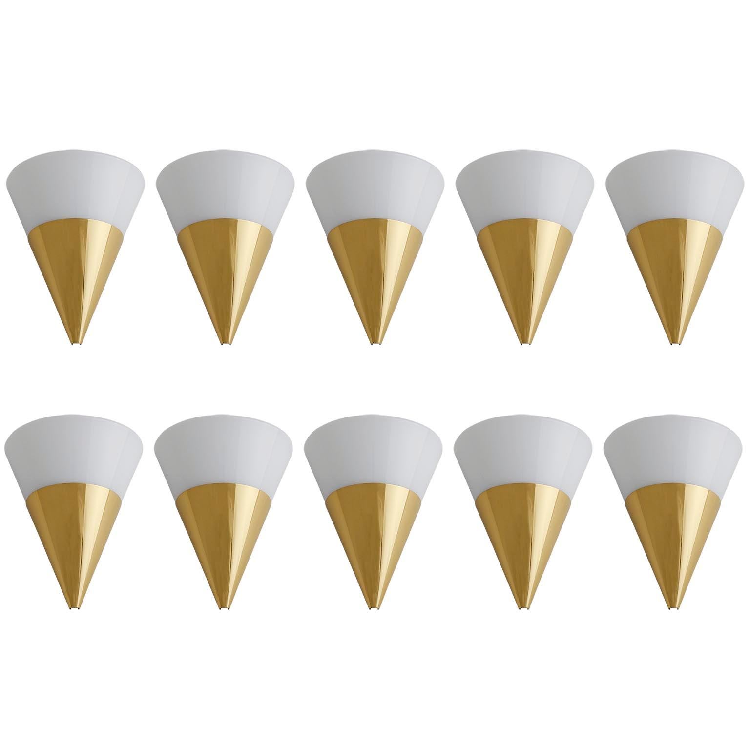 One of six half cone shaped wall light fixtures by Glashütte Limburg manufactured in midcentury, circa 1970.
They are made polished solid brass and opaline glass.
Each fixture has one socket for a medium screw base (max. 60 W) and is labeled on the