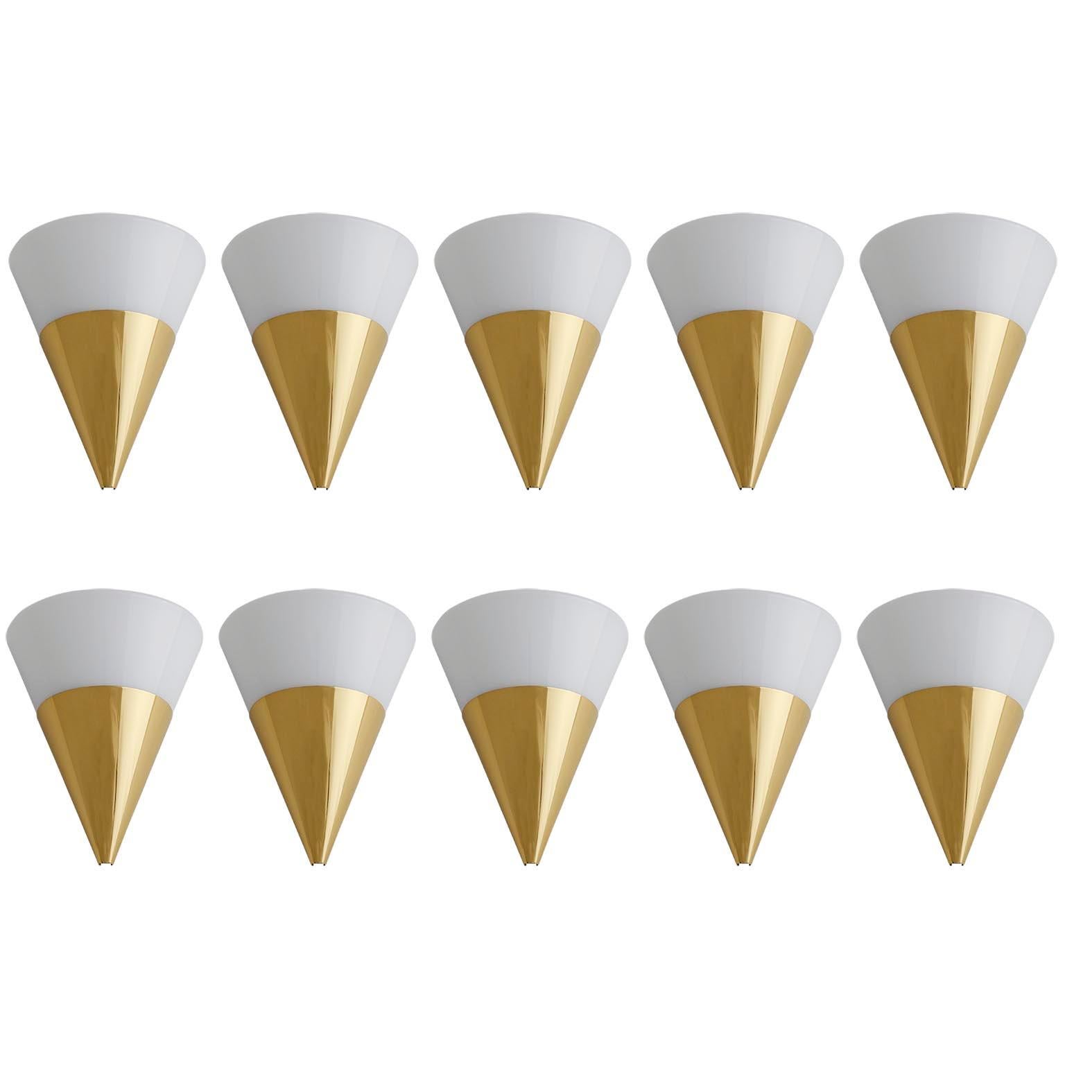 One of six half cone shaped wall light fixtures by Glashütte Limburg manufactured in midcentury, circa 1970.
They are made polished solid brass and opaline glass.
Each fixture has one socket for a medium screw base (max. 60 W) and is labeled on the