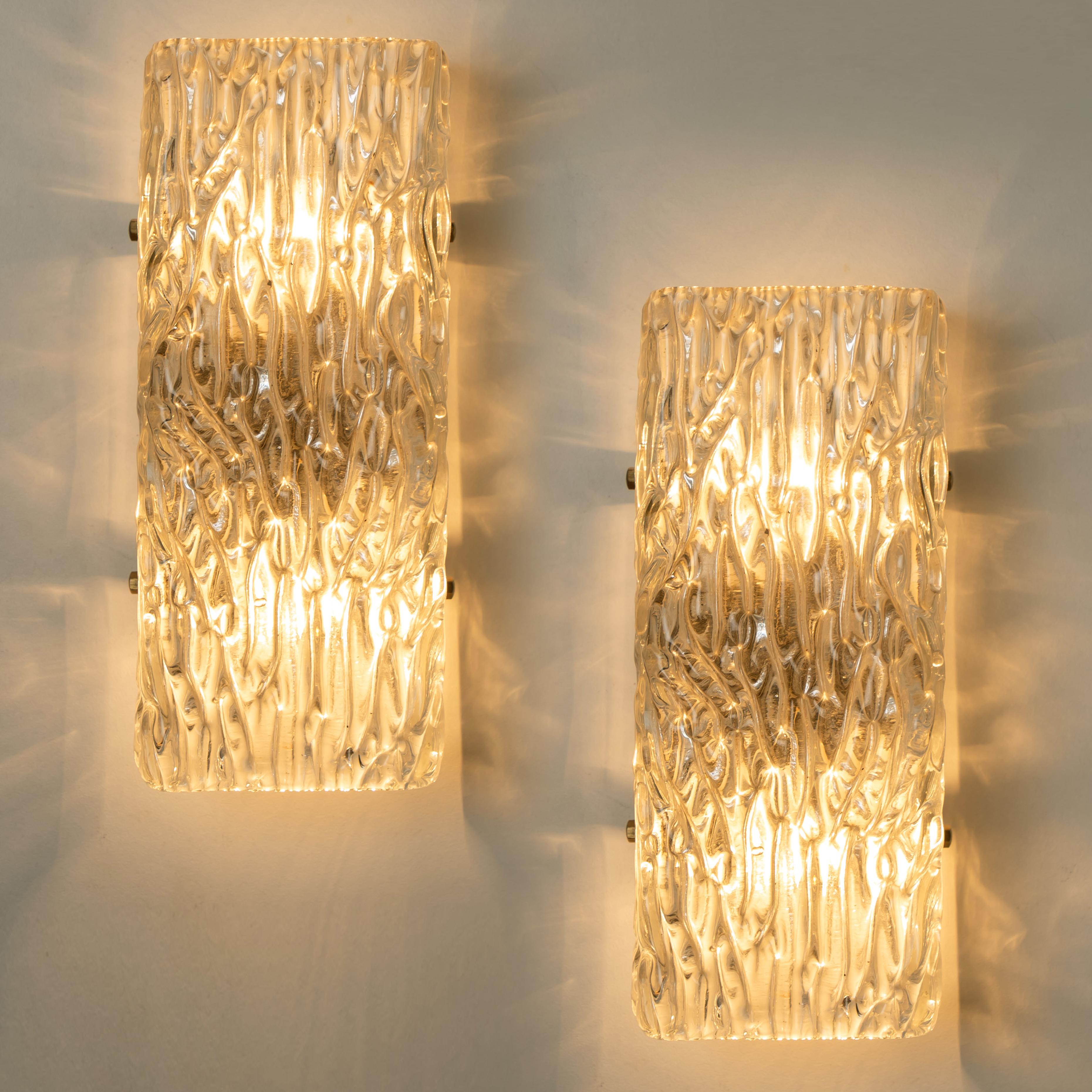 One of the nine light fixtures. T by J.T. Kalmar, Vienna, Austria, manufactured in circa 1960. The glass has beautiful wave texture in it, what gives a nice diffuse light effect and a nice pattern on ceiling, walls and floor. 
The stylish elegance