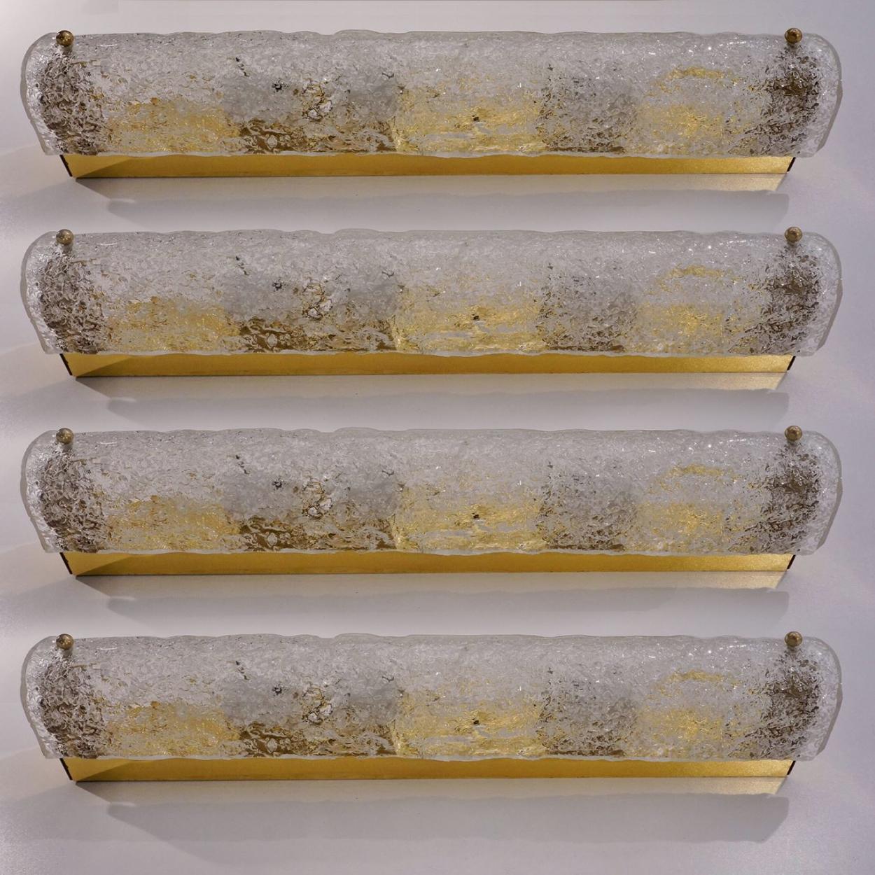 One of the four high-end Murano glass on a brass base sconces by Hillebrand, Germany, circa 1960s. Length 19,6 inch
It consists of textured quality clear crystal tubular shade simulating ice on brass frame.

The design allows this light to be placed