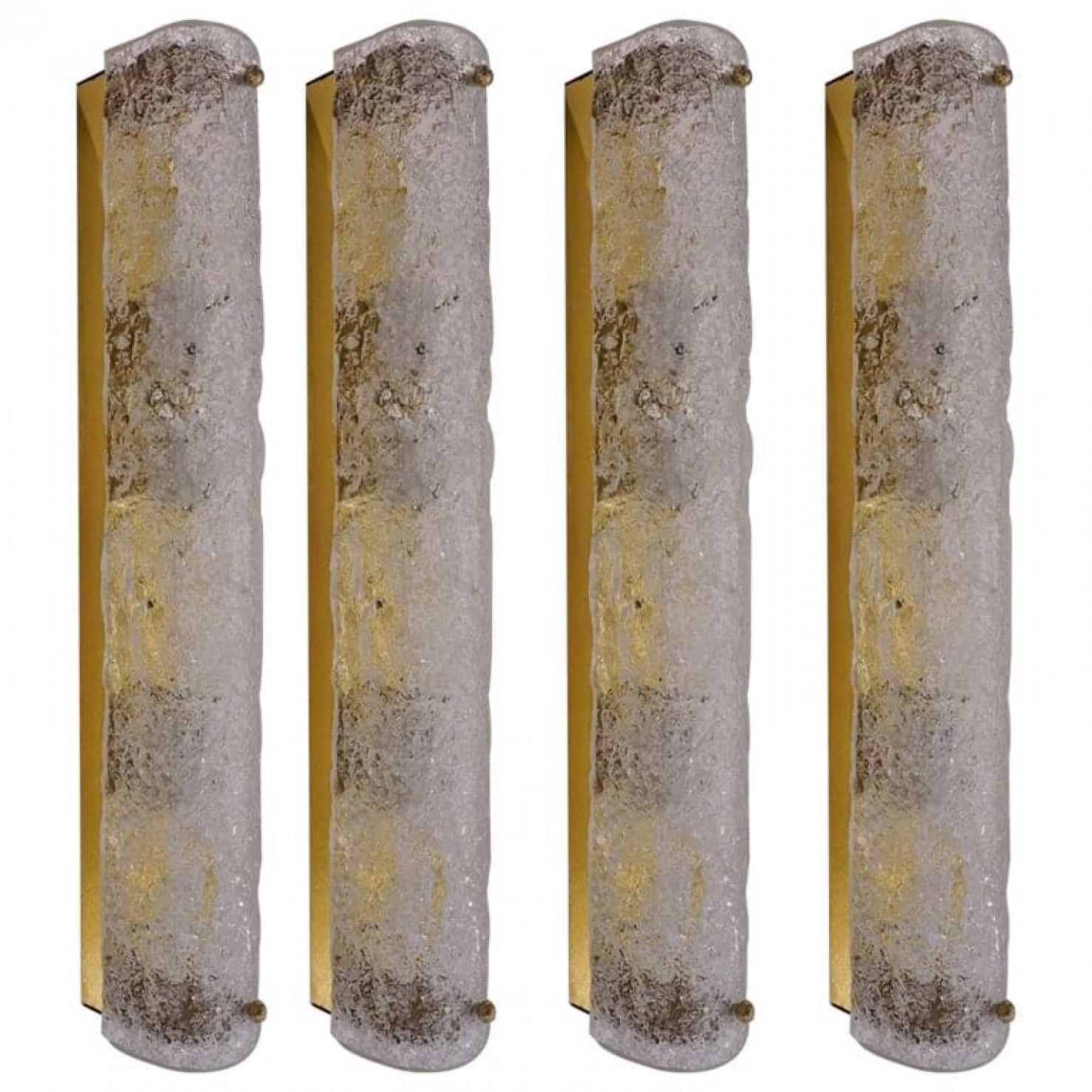 One of the four high-end Murano glass on a brass base sconces by Hillebrand, Germany, circa 1960s. Length 23.6 inch
It consists of textured quality clear crystal tubular shade simulating ice on brass frame.

The design allows this light to be placed