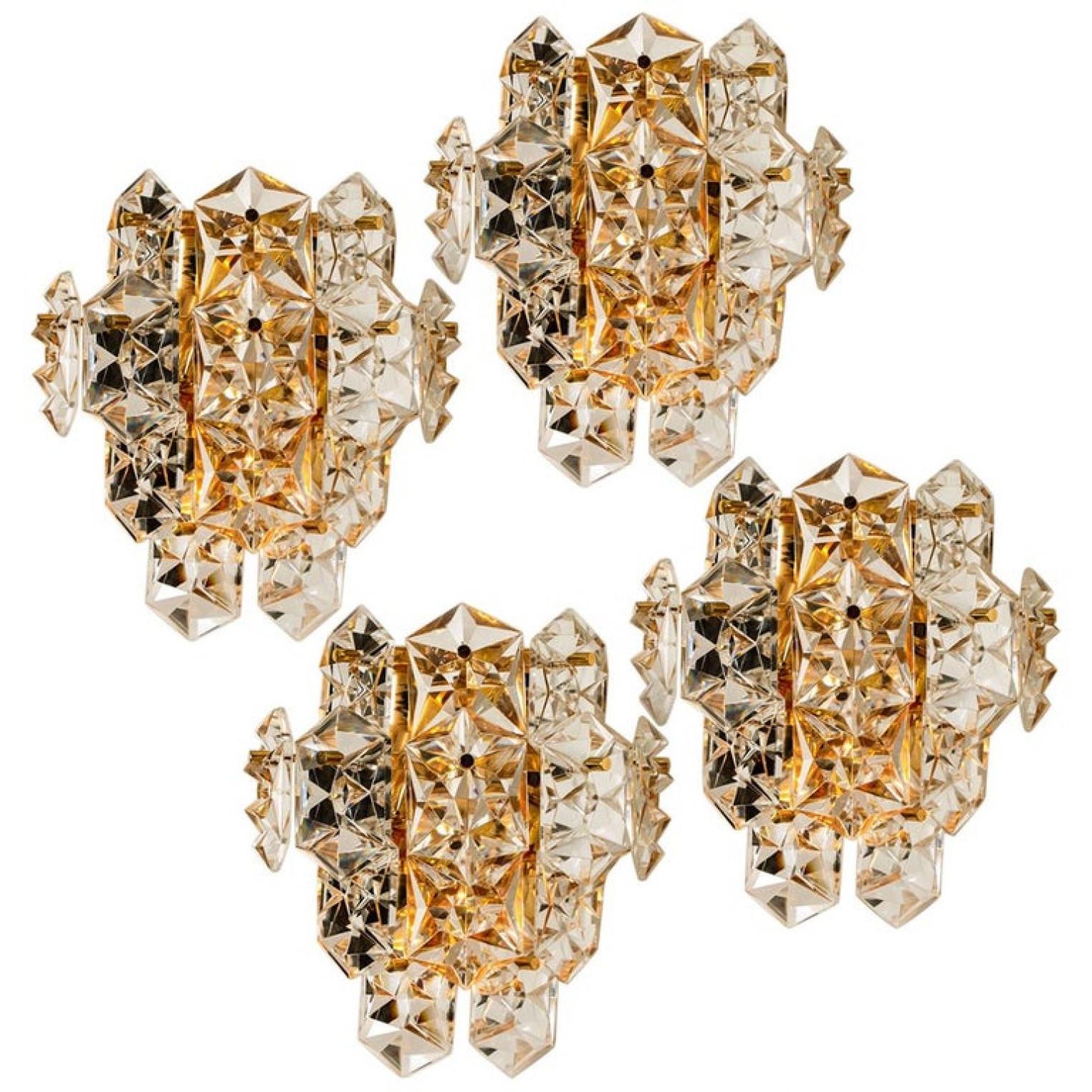 1 of the 4 luxurious pair of gold-plated frames and thick diamond crystal sconces by the famed maker, Kinkeldey. Very elegant light fixtures, comfortable with all decor periods. The crystals are meticulously cut in such a way that radiate the light
