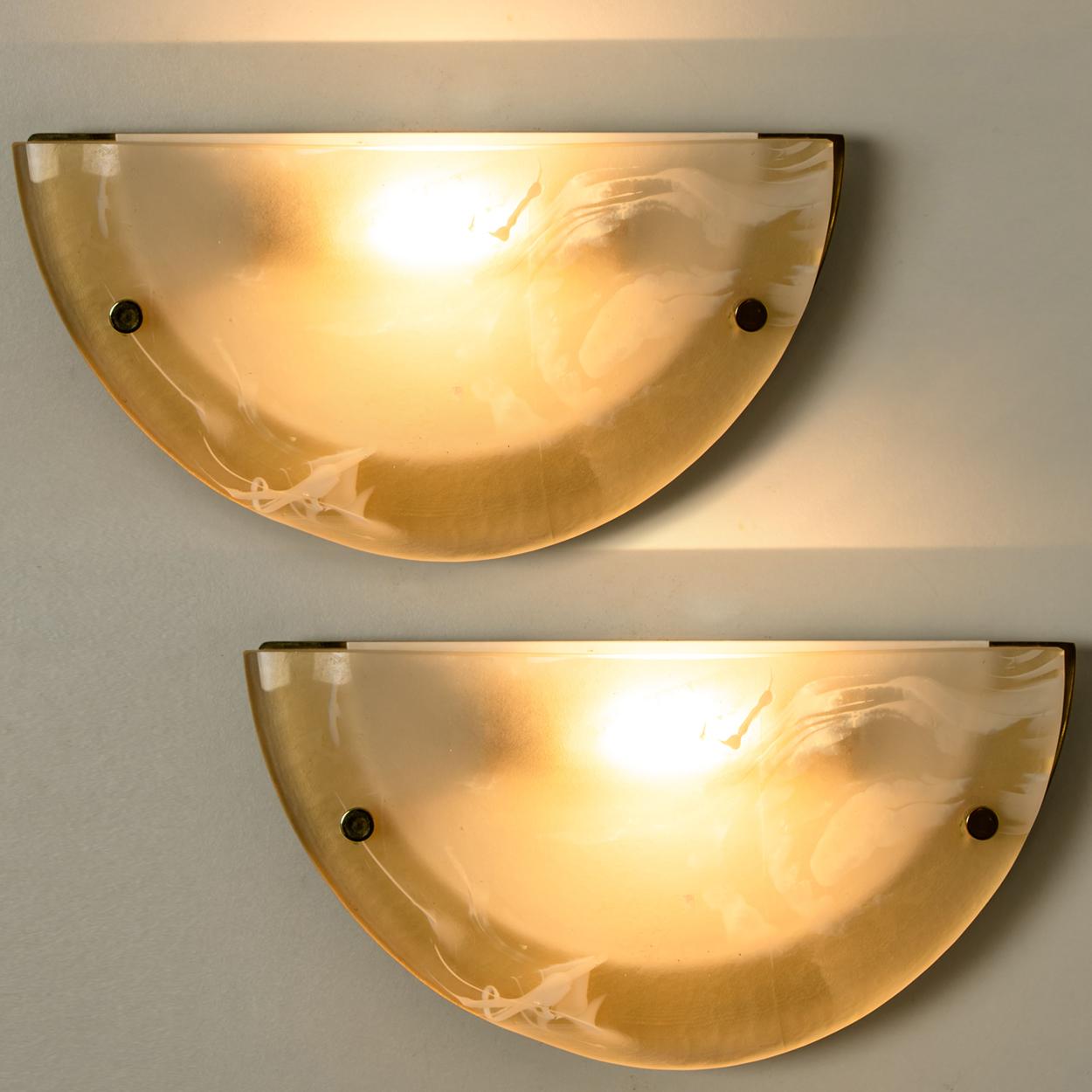 One of the four pairs of high quality modern thick textured ice glass flush mount or wall lights by Hillebrand, circa end 1960 beginning 1970.
Each light fixture is featuring a huge round blown half glass dish. Minimalistic design executed with a