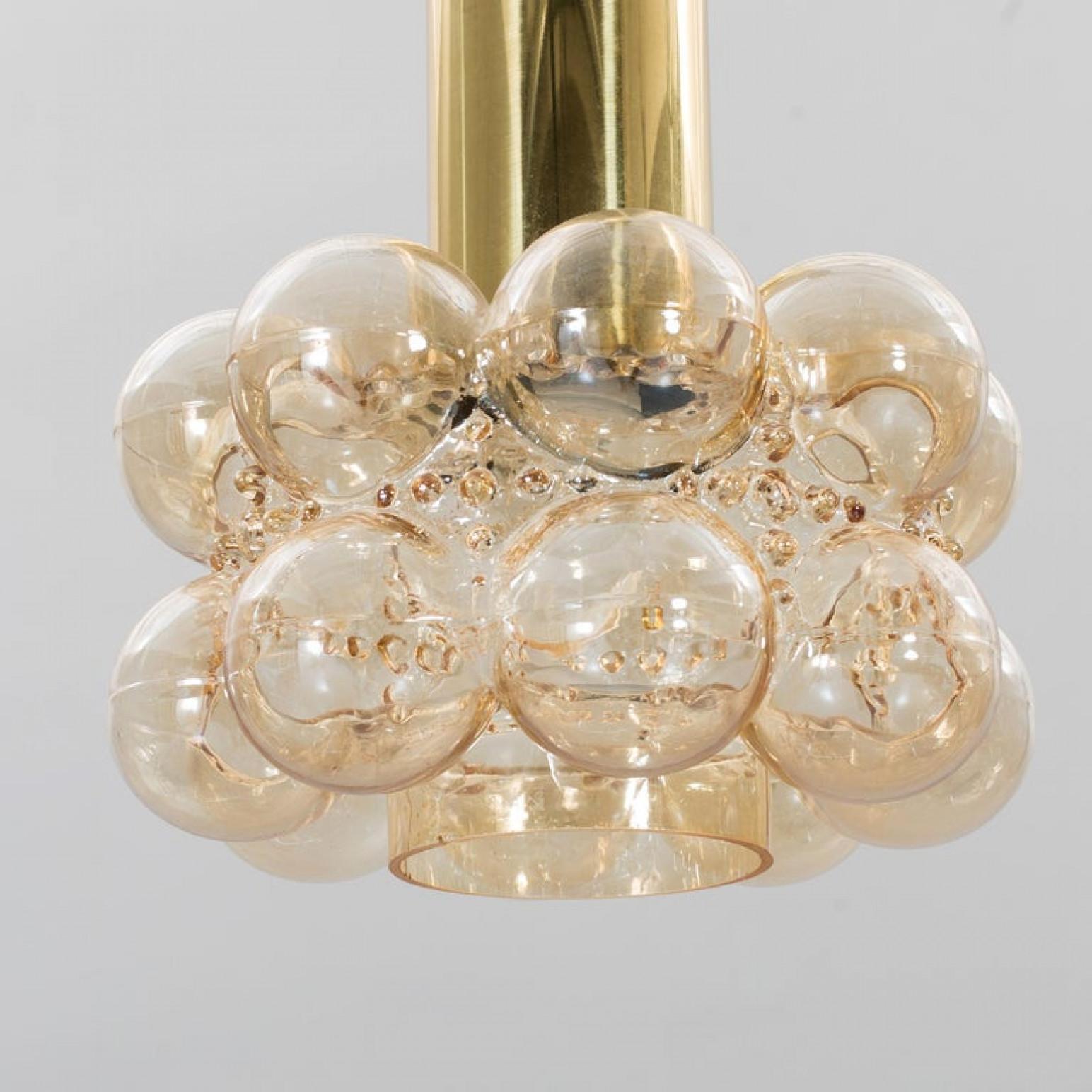 One of the six beautiful bubble glass chandeliers or pendant lights designed by Helena Tynell for Glashütte Limburg. A design Classic, the hand blown glass gives a wonderful warm glow.

The dimensions: Height 80 cm from ceiling, the diameter 30 cm.