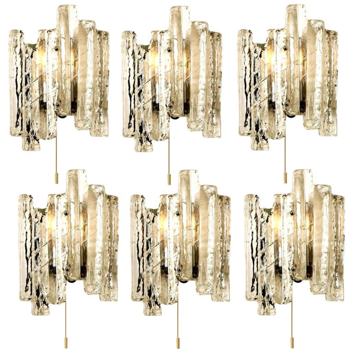 One of the six elegant modern high-end large brassed topped metal lights or sconces, Austria in the 1970s. Lovely design, executed to a very high standard. Each wall light has four solid ice glass sheets dangling on it. Clean lines to complement all