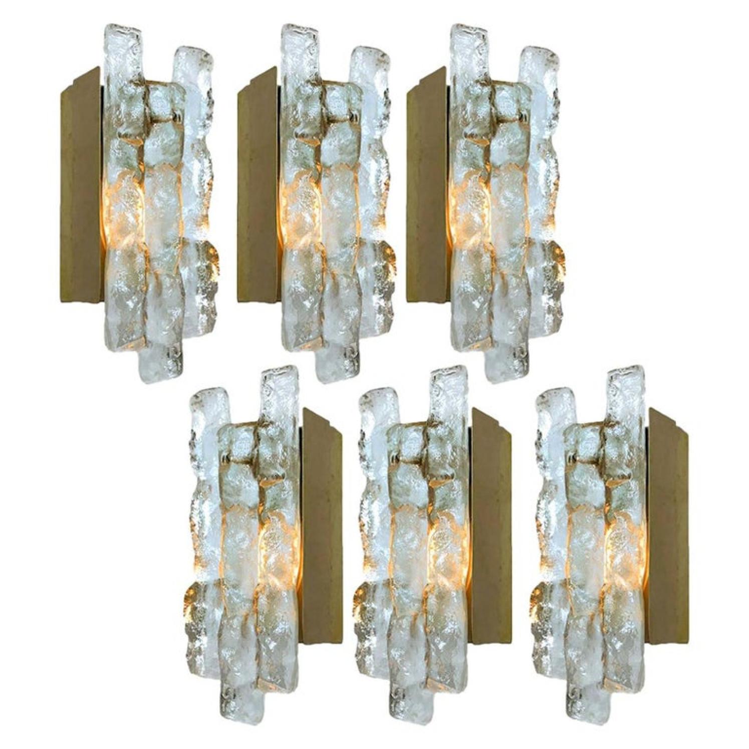 Set of beautiful and elegant modern brass wall lights/sconces, manufactured by J.T. Kalmar Austria in the 1970s. Lovely design, executed to a very high standard. Each wall light has one solid ice glass sheets dangling on it. Clean lines to