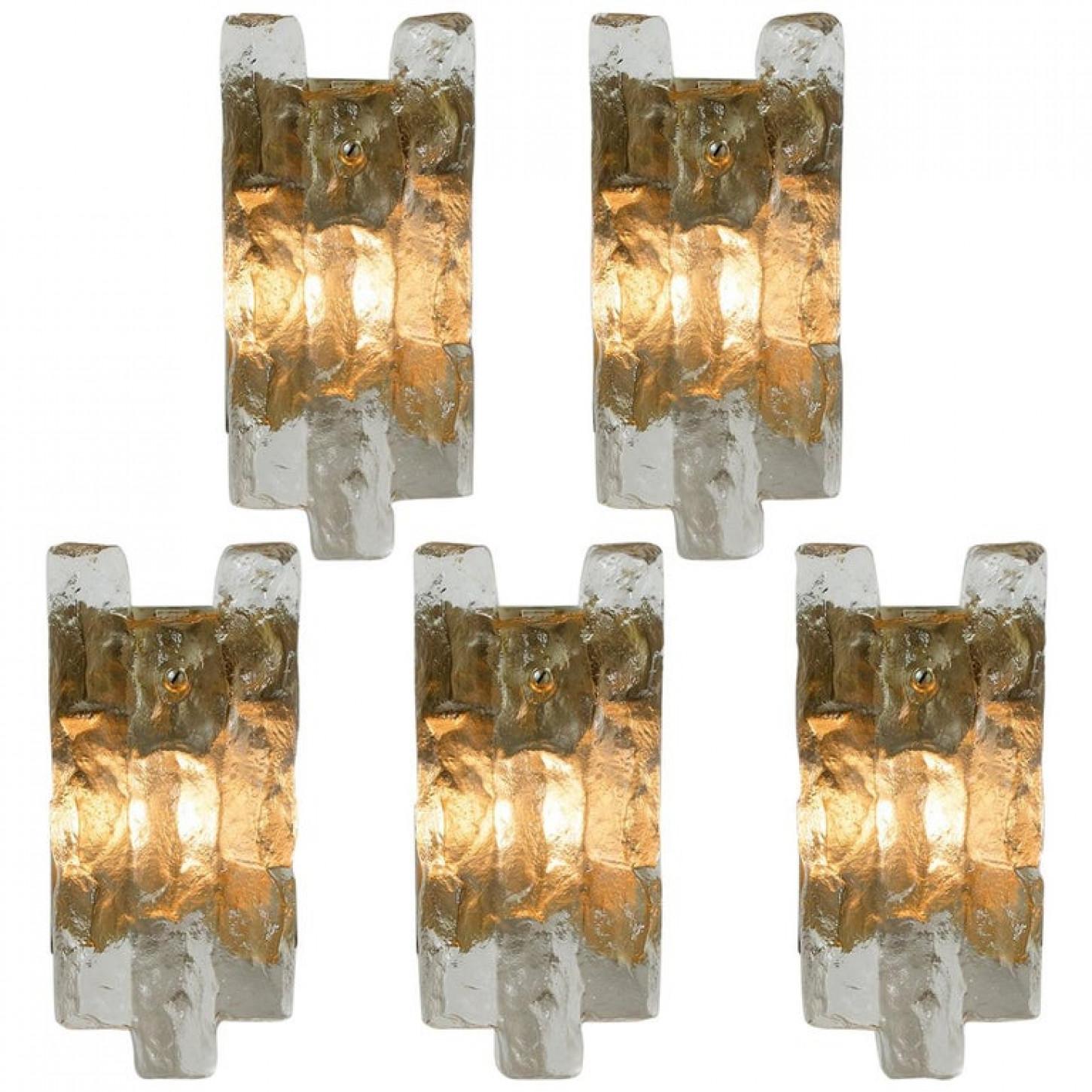 Set of beautiful and elegant modern brass wall lights/sconces, manufactured by J.T. Kalmar Austria in the 1970s. Lovely design, executed to a very high standard. Each wall light has one solid ice glass sheets dangling on it. Clean lines to