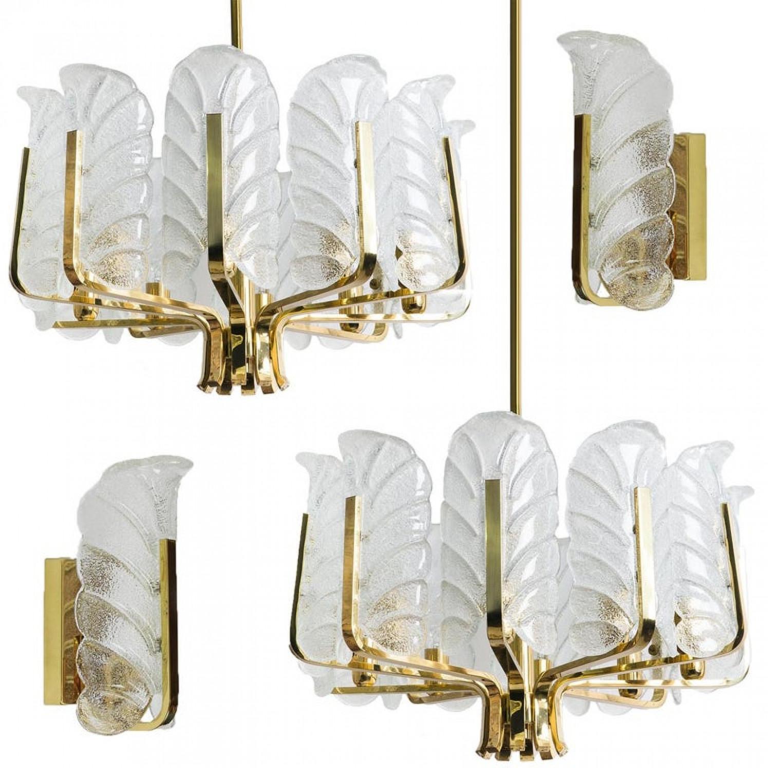 This beautifully and stunning pendant chandelier with ten glass shades and brass fittings was produced in the 1960s by the iconic firm of Orrefors and designed by Carl Fagerlund. Beautifully carved clear frosted glass shades in a leaf design on