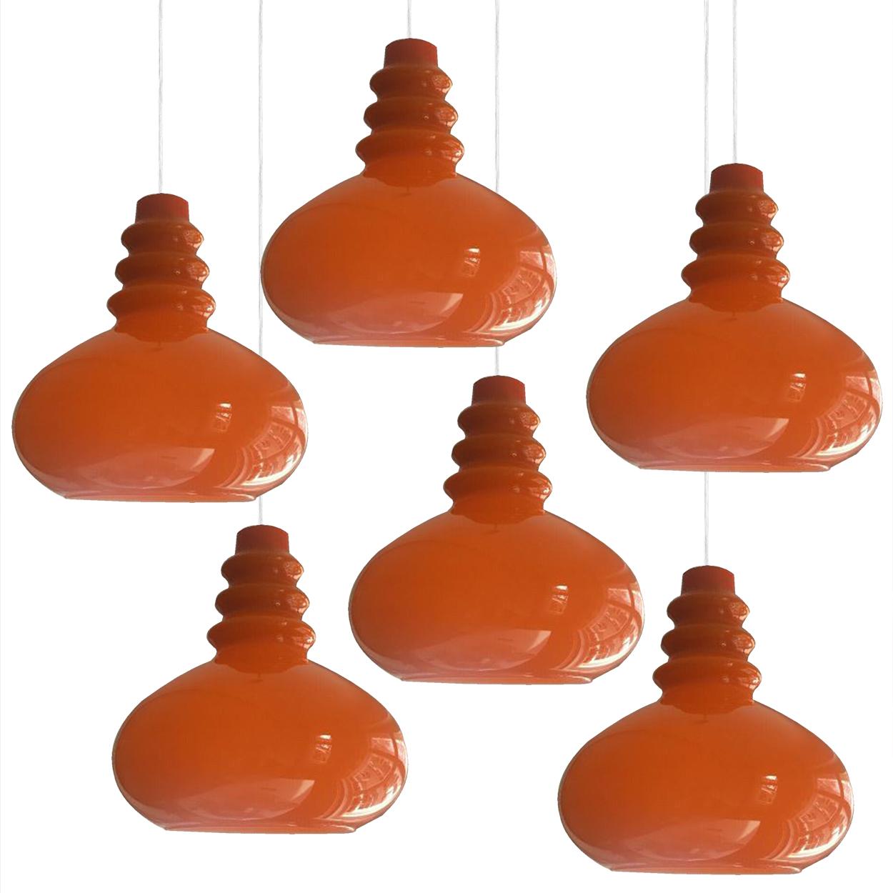 There’s something about orange that screams this particular era. And this 1970s pair of Peil & Putzler ceiling pendant lamps is very orange! Image 1 is the lamp with the light on.

The lovely shaped lampshade is made of a ‘cast opaque orange