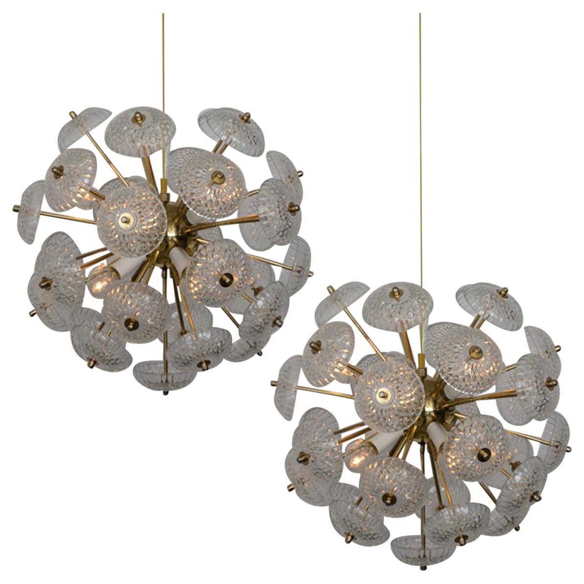 One of the three pairs stunning large brass chandeliers in the style of Emil Stejnar. Manufactured in the 1960s.
Very heavy made of brass with stylish glass disc glass light diffuses. The glass pieces are beautifully cut with a fine eye for detail,