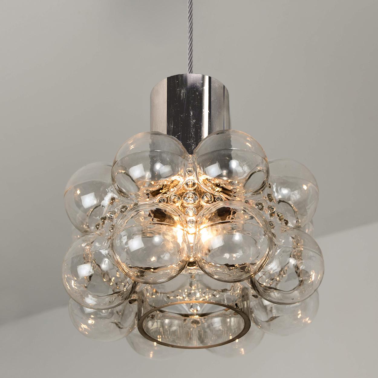 One of the three beautiful bubble glass chandeliers or pendant lights designed by Helena Tynell for Glashütte Limburg. A design Classic, the hand blown glass gives a wonderful warm glow.

The dimensions: Height 80 cm from ceiling, the diameter 30