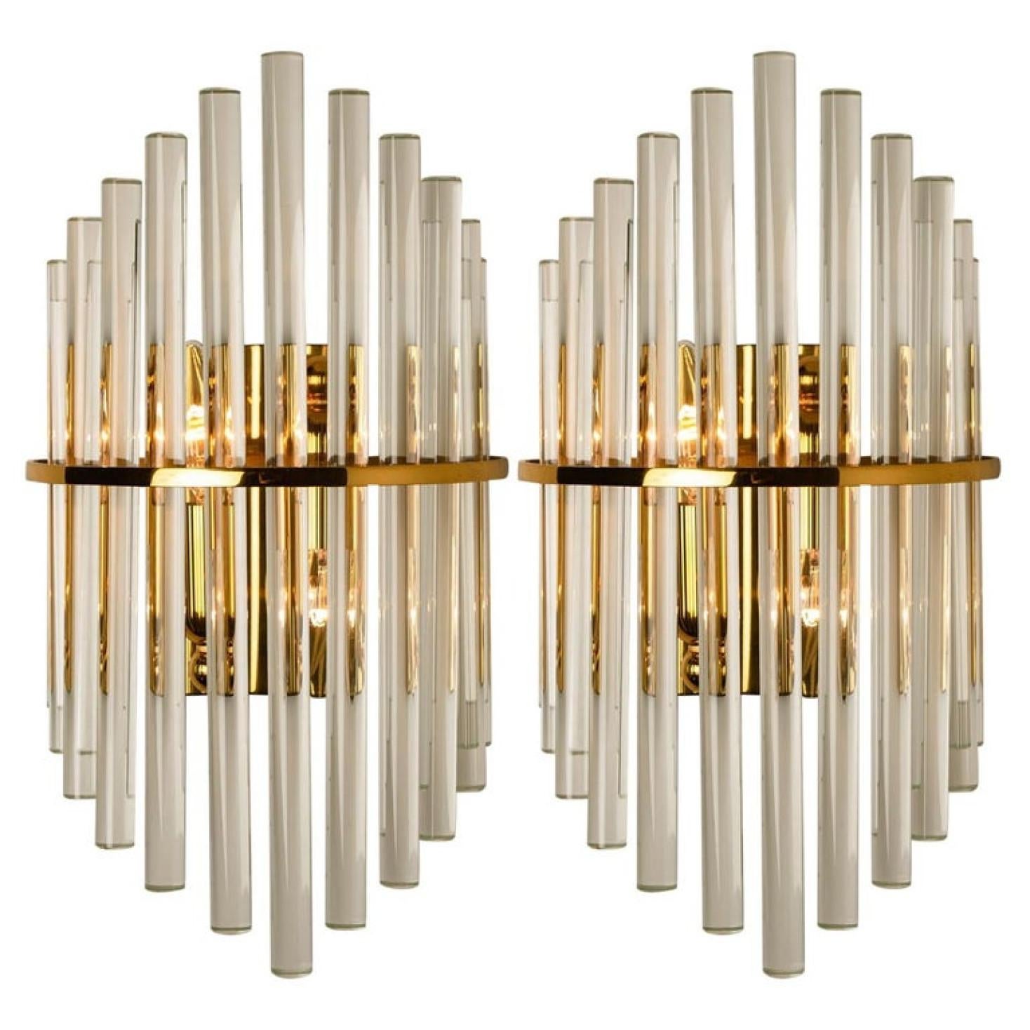 Clean lines to complement all decors. A wonderful pair of high-end wall lights for Lightolier. With brass detail and hanging waterfall glass giving each piece an elegant appearance which refracts the light, filling a room with a soft, warm