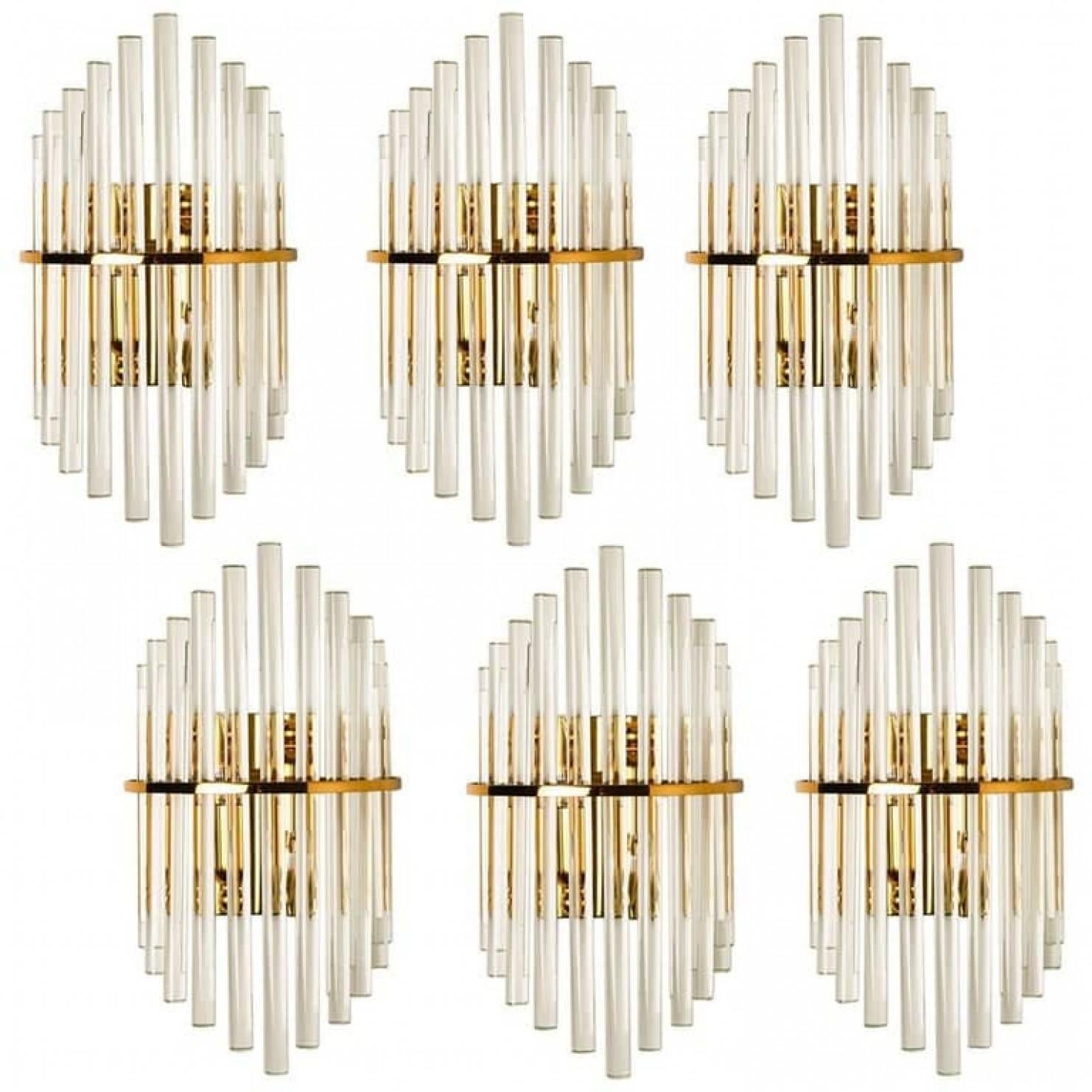 Clean lines to complement all decors. A wonderful pair of high-end wall lights for Lightolier. With brass detail and hanging waterfall glass giving each piece an elegant appearance which refracts the light, filling a room with a soft, warm