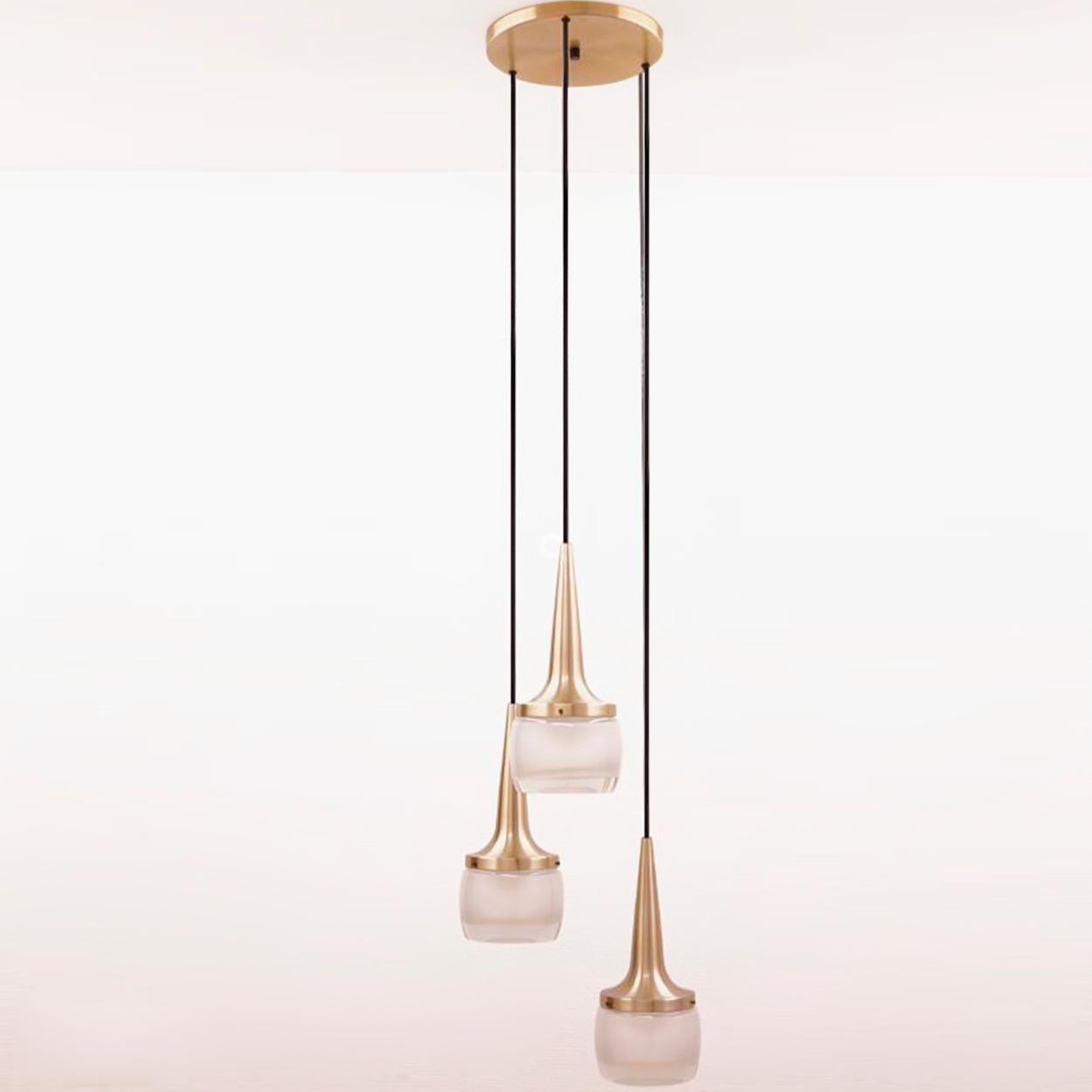 This elegant cascade light was manufactured by Staff Leuchten in Germany. The light is executed in brassed aluminium and thick opaline molded glass etched on the inside. Each individual pendant measures: 13.5 in. H x 5.25 in. D. 

Dimensions