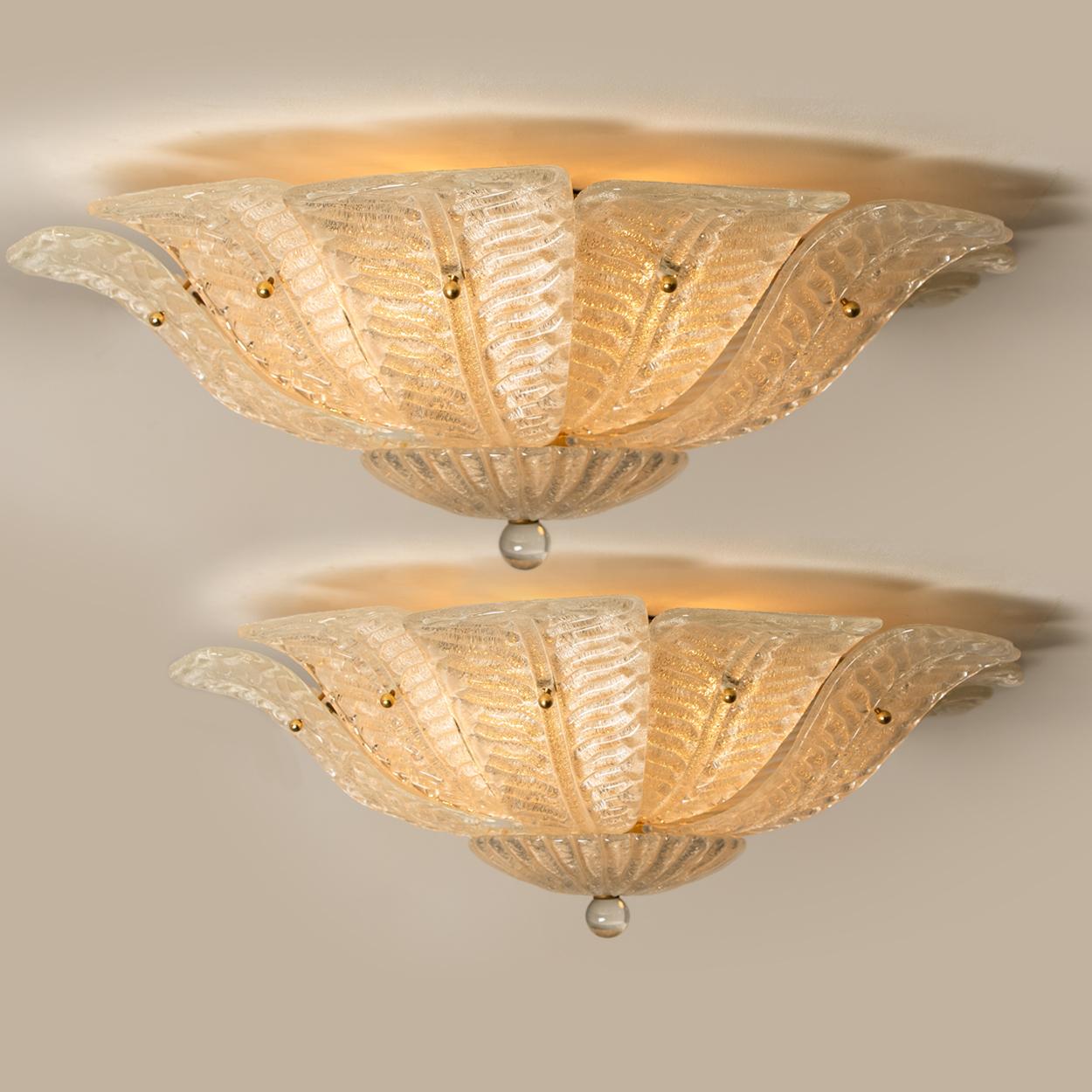 An elegant hand blown Murano glass flushmount of Barovier & Toso. The light fixture consists 16 blown Murano glass leaves. Mounted on a brass frame. The leaves refract light beautifully. The flushmount fills the room with a soft, warm and welcoming