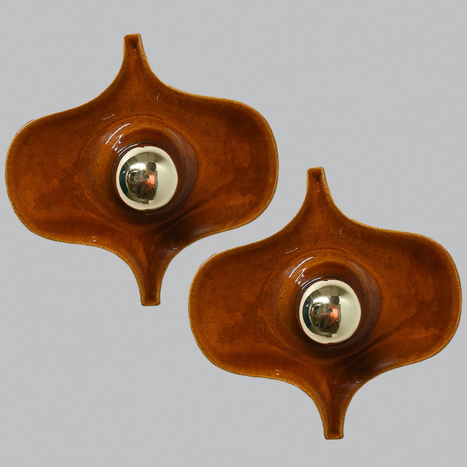 Piar of Brown ceramic wall lights in Fat Lava style. Manufactured by Hustadt Leuchten Keramik, Germany in the 1970s.

Measurements:
Width: 8.26 in (21 cm)
Heigth: 7.87 in (20 cm)
Depth: 4.72 in (12 cm)

Please note the price is for a pair. We have a