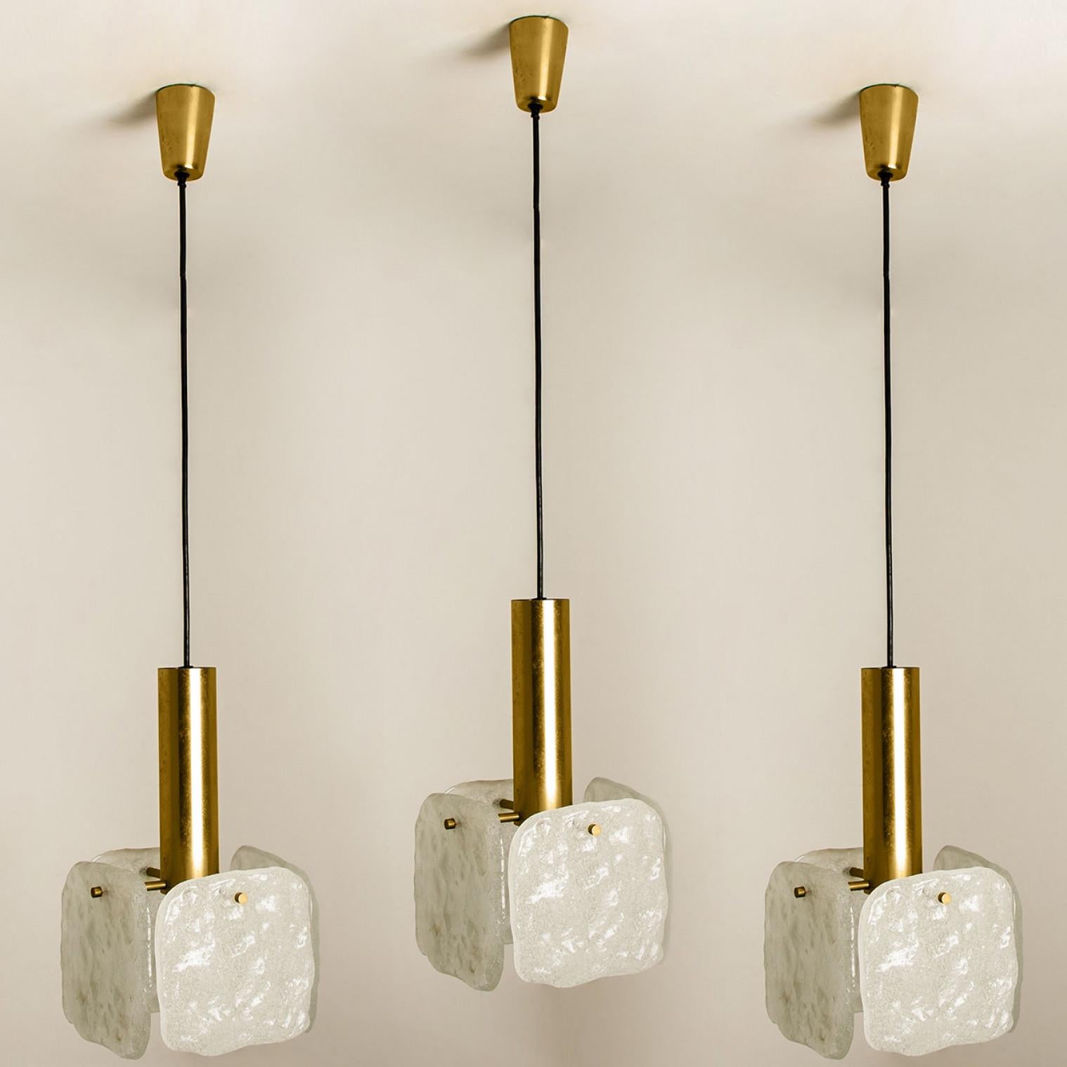 One of the three ice glass pendant lights designed by J.T Kalmar, manufactured by Kalmar Franken, Austria in the 1960s.
Stunning design, each pendant has four large squares of white, opaque textured glass (each approximately 17cm x 17m) provides a