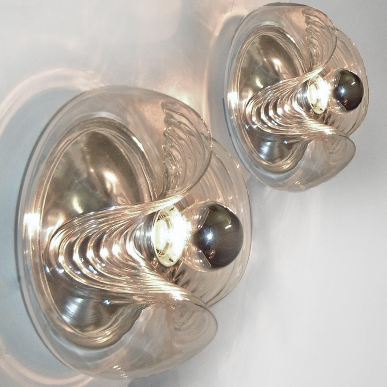 Pair of mid-20th century flushmount or wall sconces designed by Koch & Lowy for Peill & Putzler in the 1970s. Featuring a clear glass globe shade with a waved or ribbed molded bubble form, casting a stunning rippled light across a wall or ceiling.
