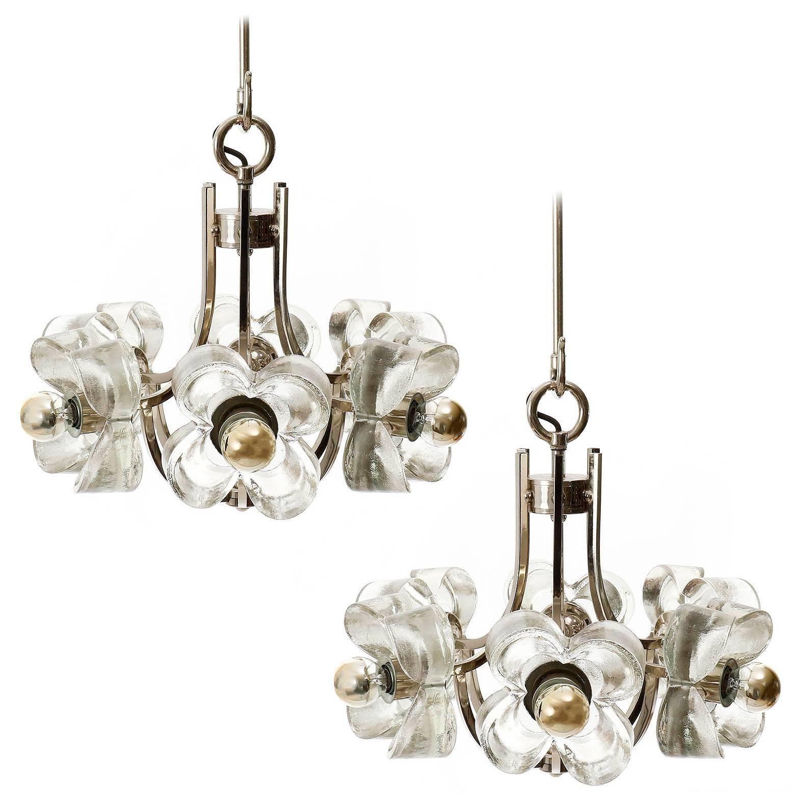 One of two beautiful floral chandeliers / pendant lamps made of ice glass and chrome-plated brass frames, manufactured in Italy in Mid-Century, circa 1970 (late 1960s or early 1970s).  
Each chandelier has six sockets for small screw base (E14