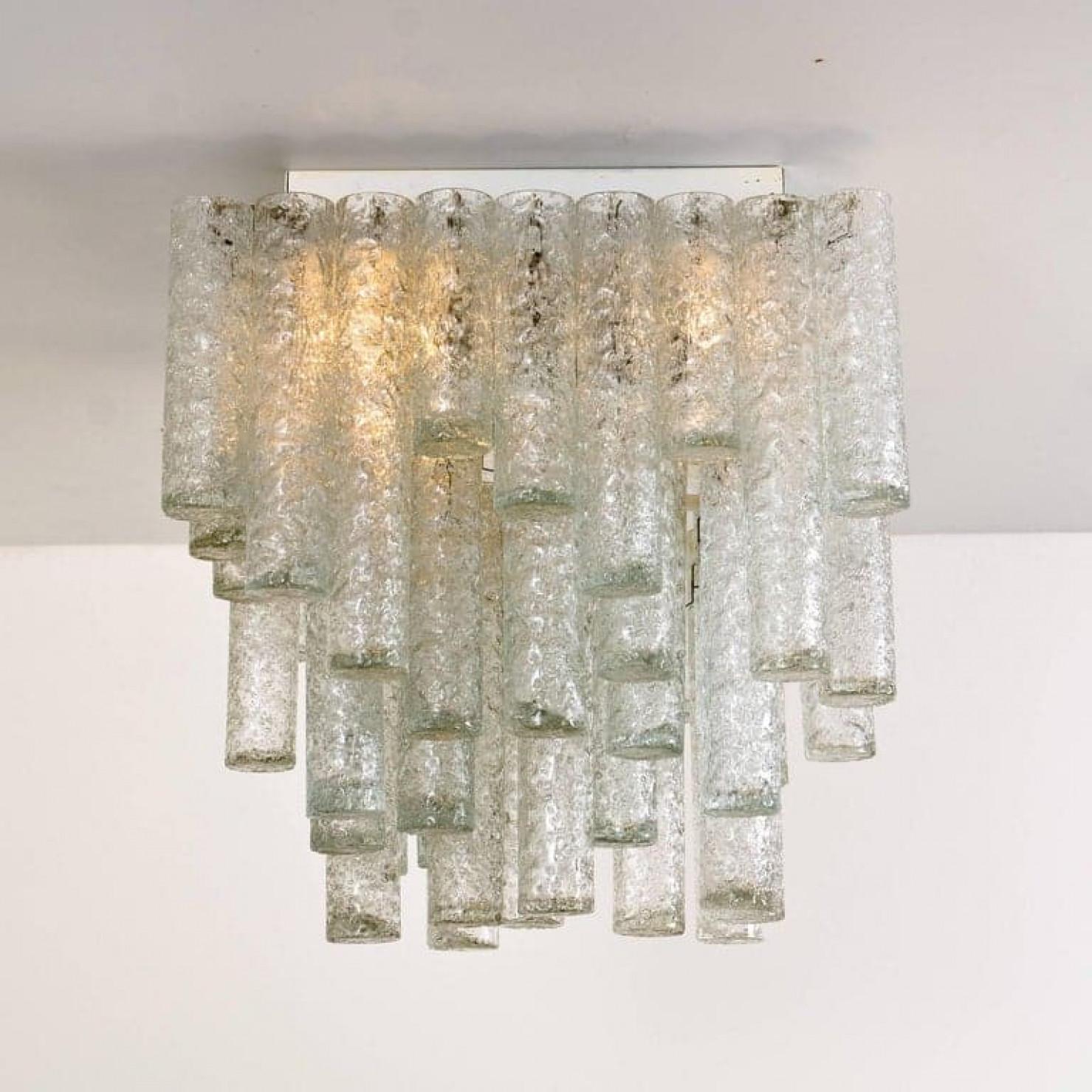 This beautiful square flushmount was manufactured by Doria in Germany in the 1960s. It consists of 47 organic glass tubes of different lengths.
This square flushmount is very unique and rare to find. The chandelier is in excellent vintage