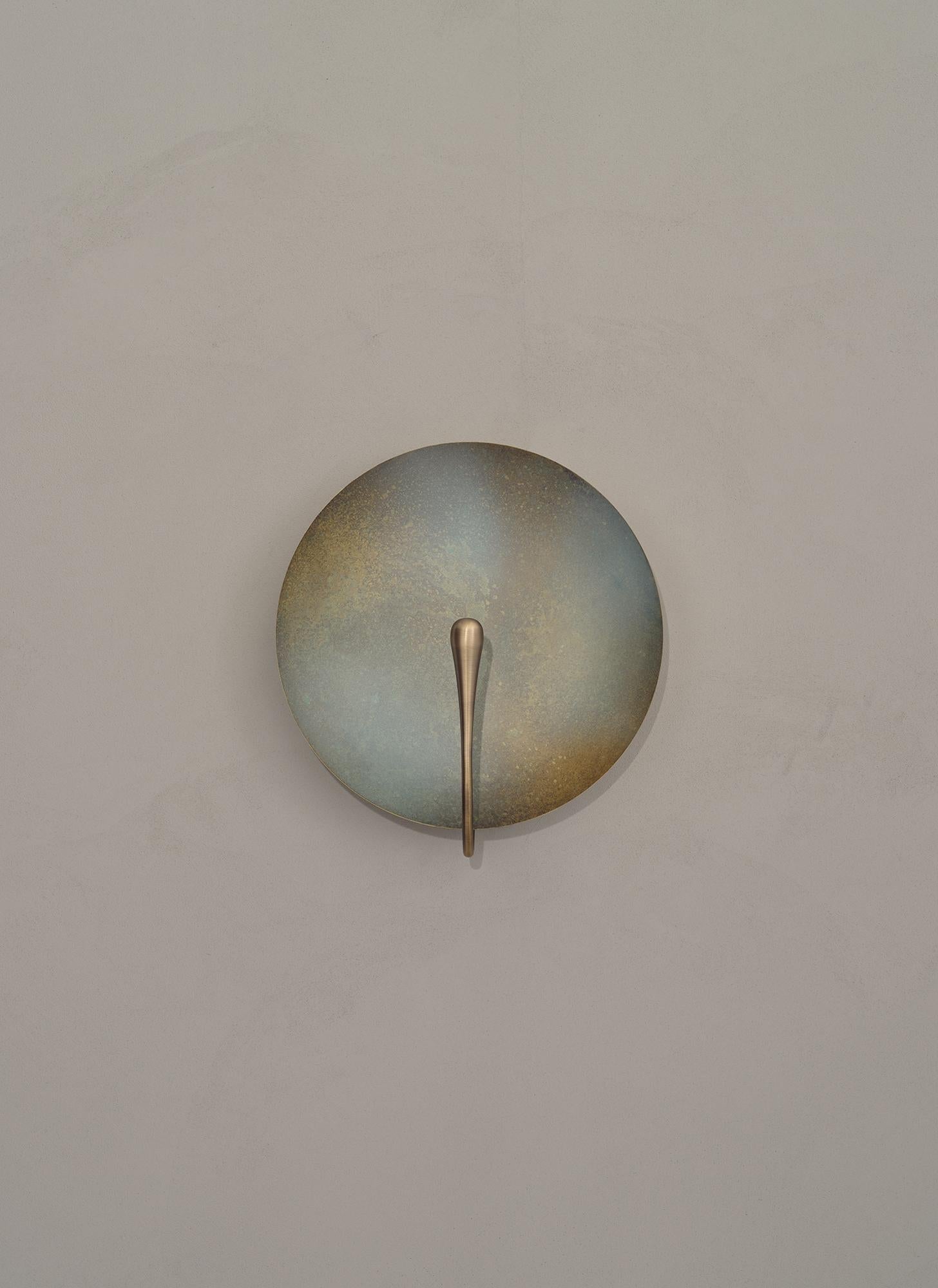 Inspired by the beautiful textures of nature, an 'Oxidium' patina is applied on a hand-spun brass plate to create this unique finish. An experiment between designer and maker, this sconce is one of a kind. 
 
Softly illuminated with integrated LED