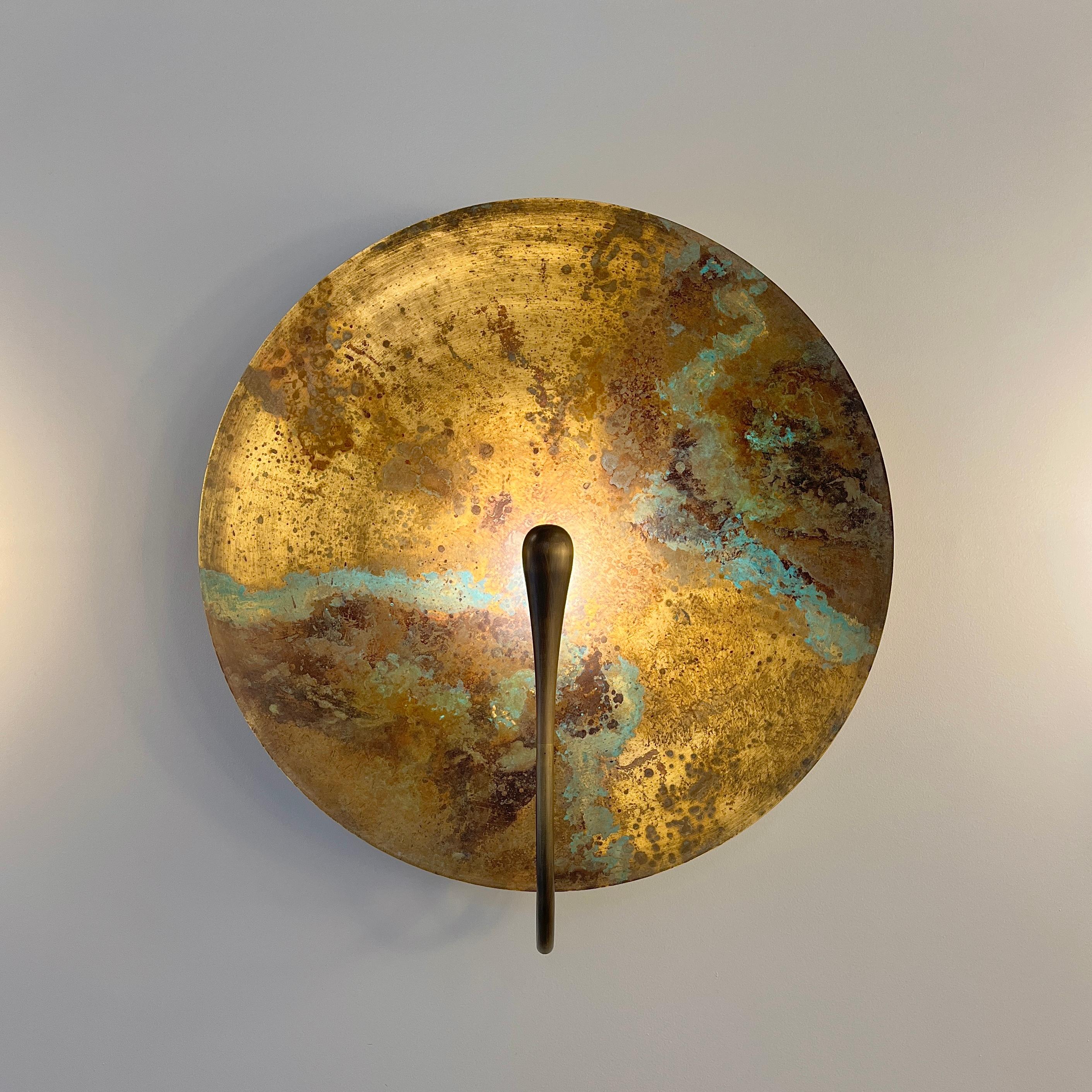 Inspired by the beautiful textures of nature, a mixed patina is applied on a hand-spun brass plate to create this unique finish. Please note each piece is individually handmade, therefore unique in its own way. Softly illuminated with integrated LED