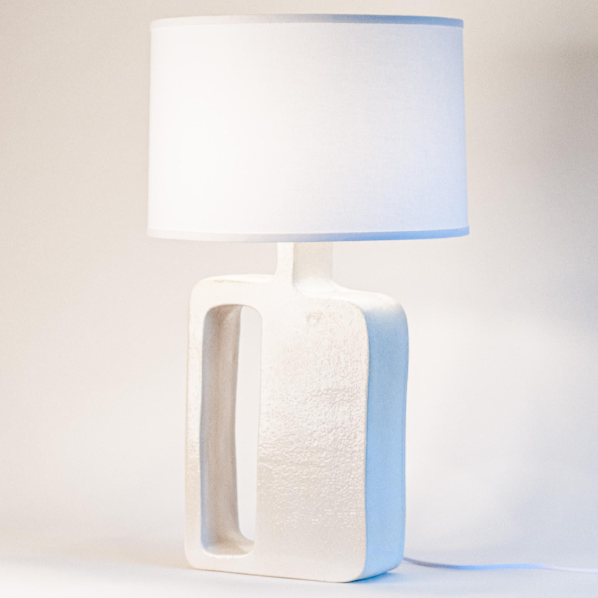 With the One-Off Table Lamp Collection we invite you to explore the captivating world of shapes. Each lamp seamlessly fuses contemporary design with the artistry of handmade geometry. Created using rough-cut stoneware slabs to showcase the natural