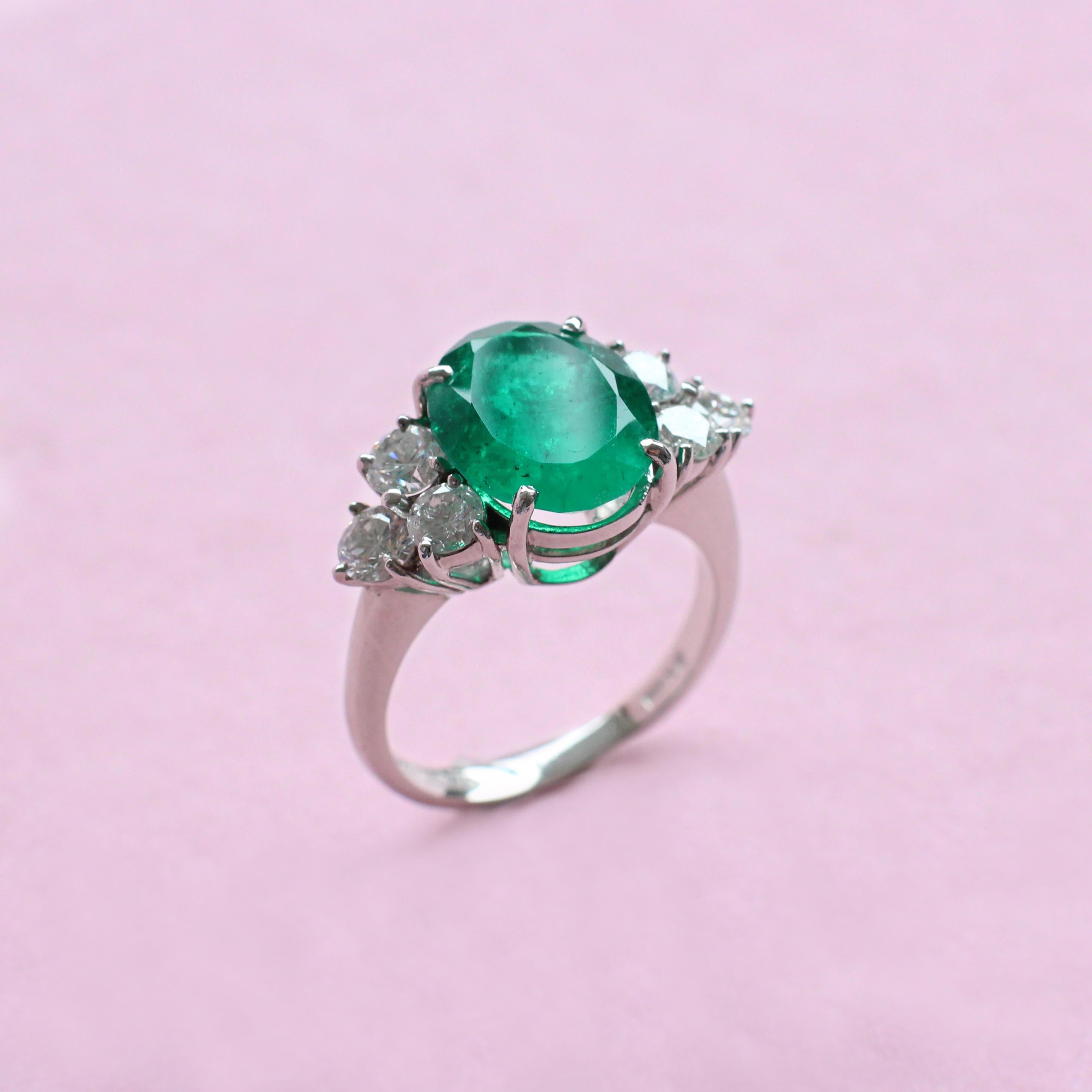 A deep green emerald truly is the star of the show in this pretty white gold ring, crafted with care by the Haruni family. The bold colour of the main stone is showcased by its simple but striking oval shape, as well as the trio of glittering white