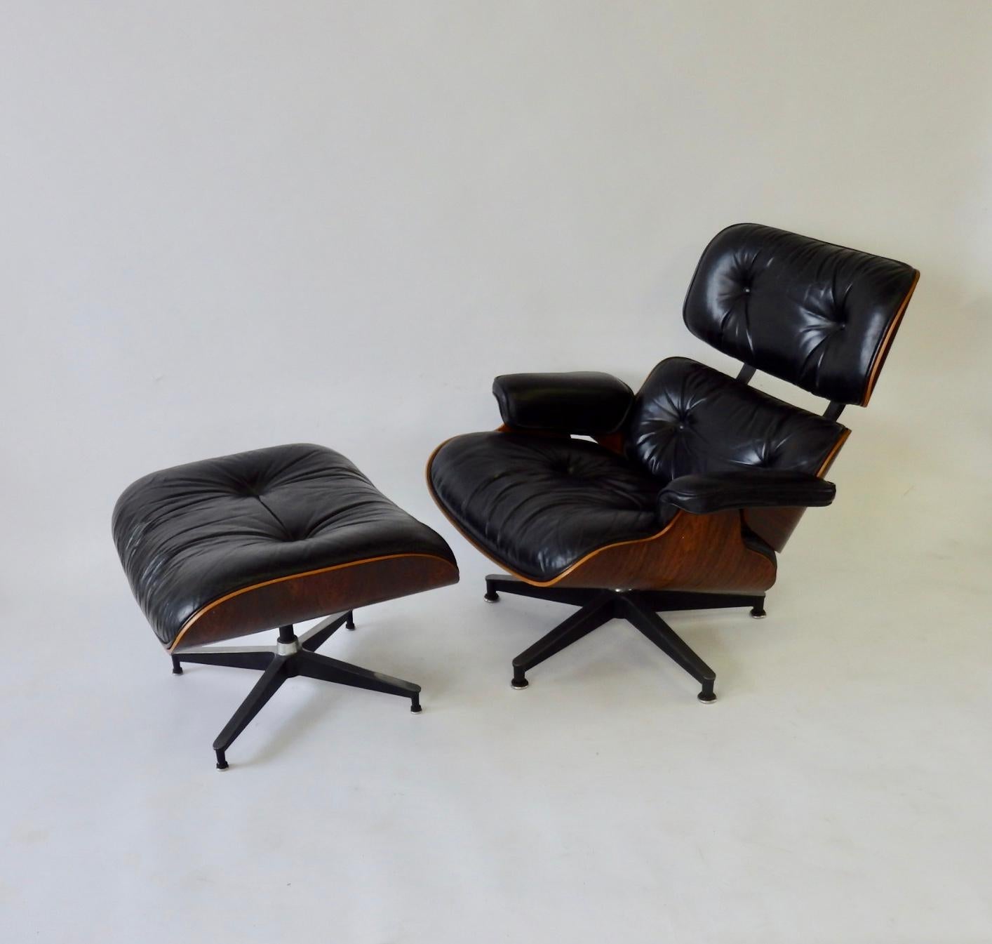 Very nicely grained Eames lounge chair. Rosewood shell with black leather upholstery. Retains gray rectangular label.