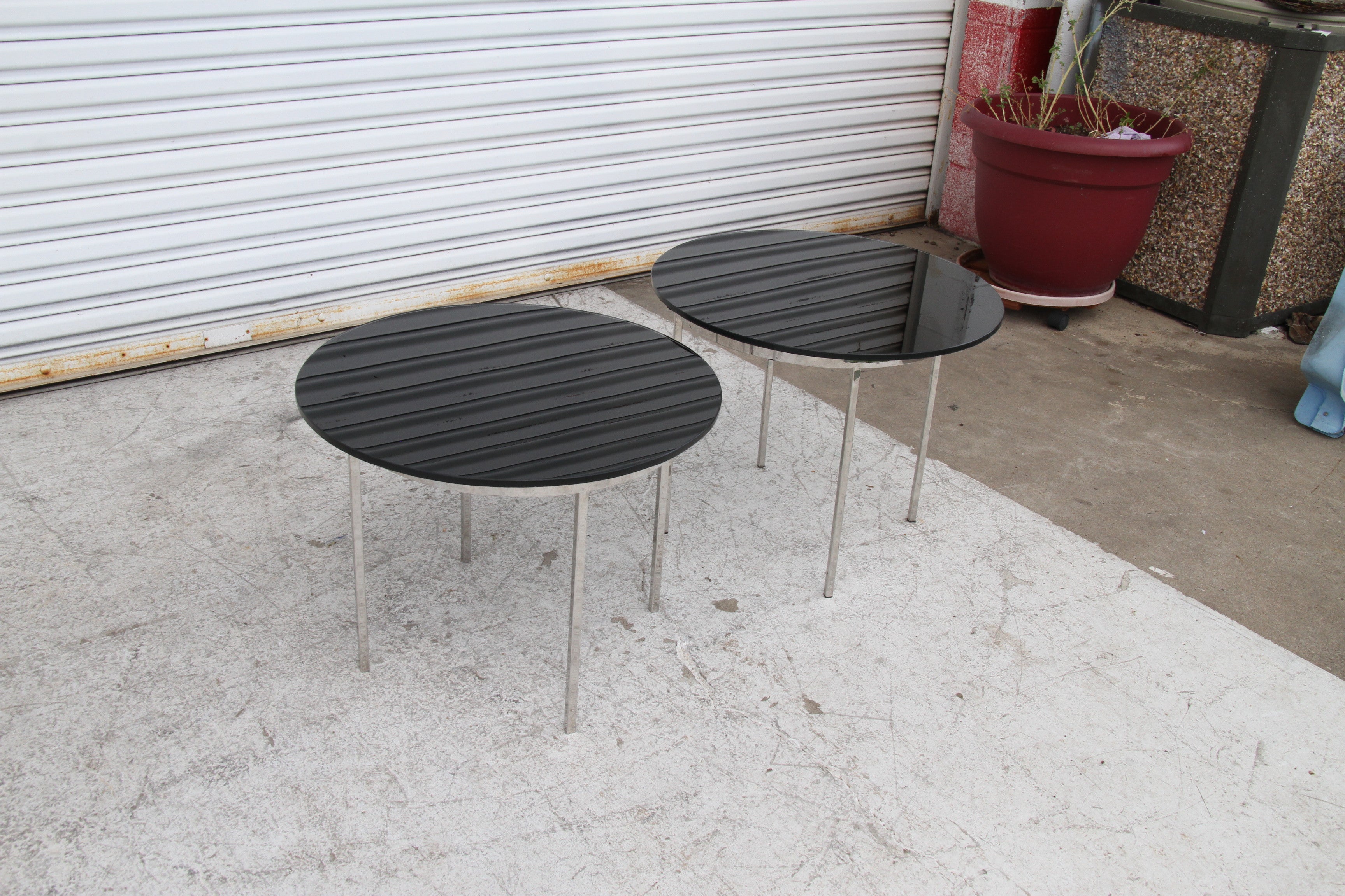 One Pair Mid Century Style Chrome Glass Side Tables in the Style of Zographos

American Mid-Century round end / side tables with circular smoked glass tops resting on chrome bases. 


Specification:
 smoked glass top with beveled edges
 22