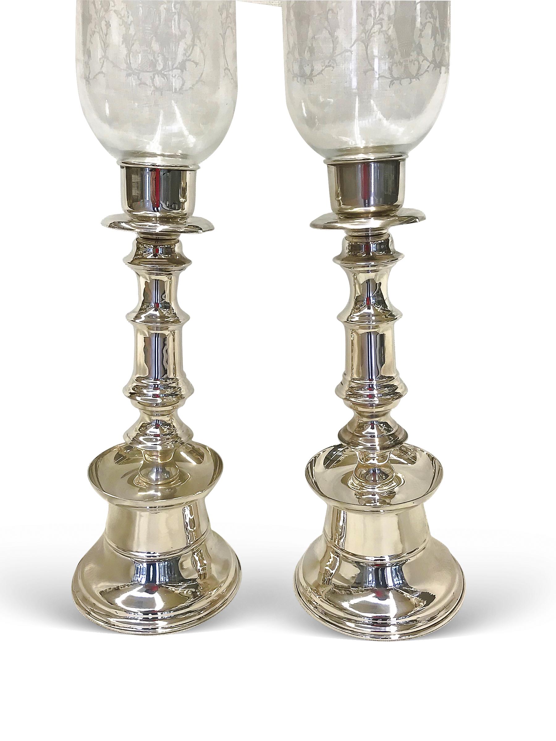 One pair candle holders with beautiful hand design and a pair of glass cover comes on top of the candle.
They are made of 0.900 silver and shiny. Could easily be cleaned. 
Weight:1028grams
W:(only the base silver) 12 1/2”
W:5”
H:20”

