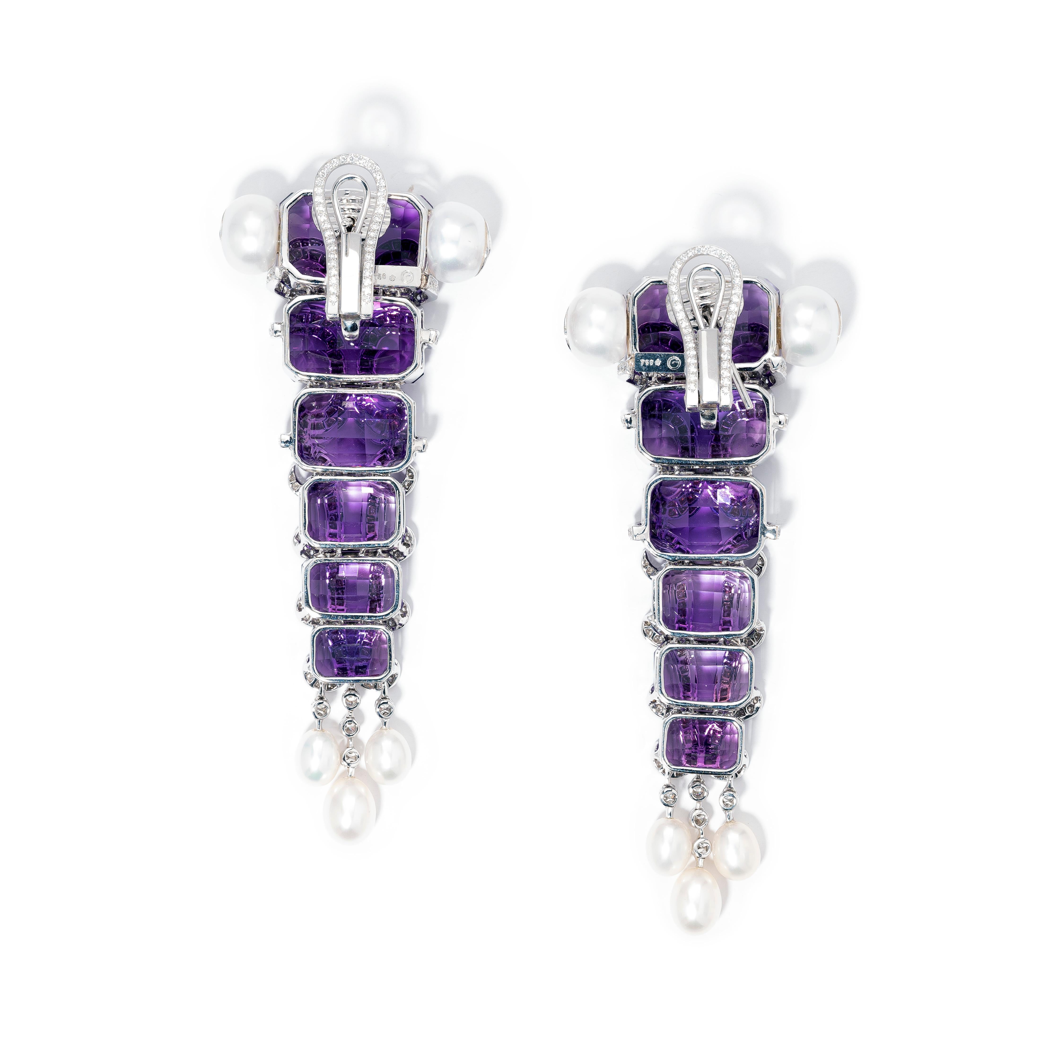 A unique pair of handmade abstract ear clips in 18K white gold set with:
12 Step cut amethyst weighing 60.36cts
4 Circular cut amethysts weighing 0.36cts
4 Button shaped cultured pearls weighing 20.00cts
6 Cultured pearls drops weighing 6.94cts
10