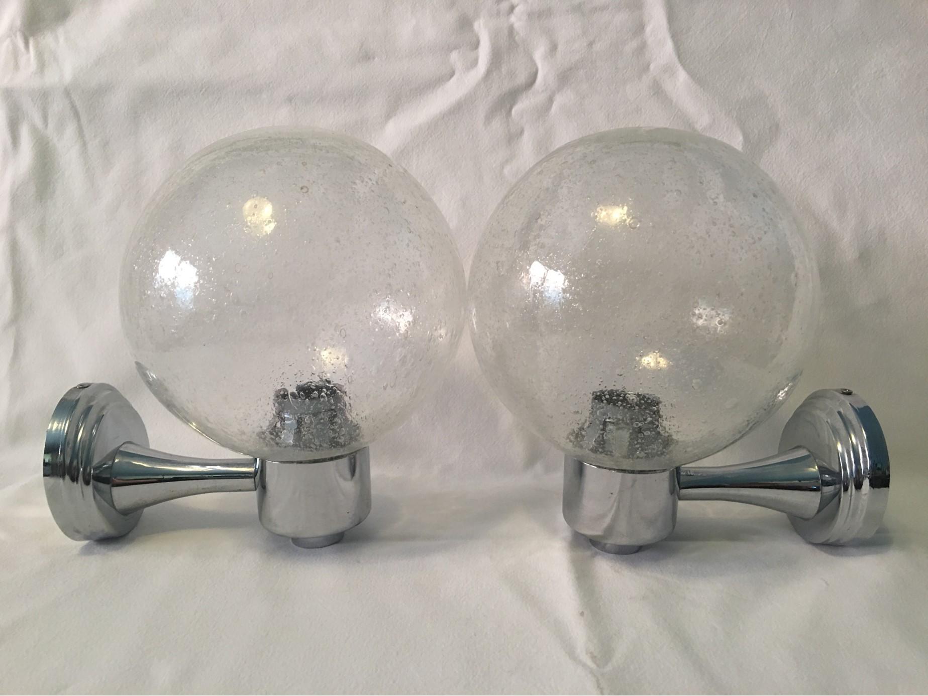 A pair of pretty Chrome and Air Bubble Glass Ball Sconces from the 1970s. When lit they create a lovely glass reflection through the Bubble Glass scheme. E#ach one requires one European E14 Candelabra Bulb up to 40 watts. The wall fixture