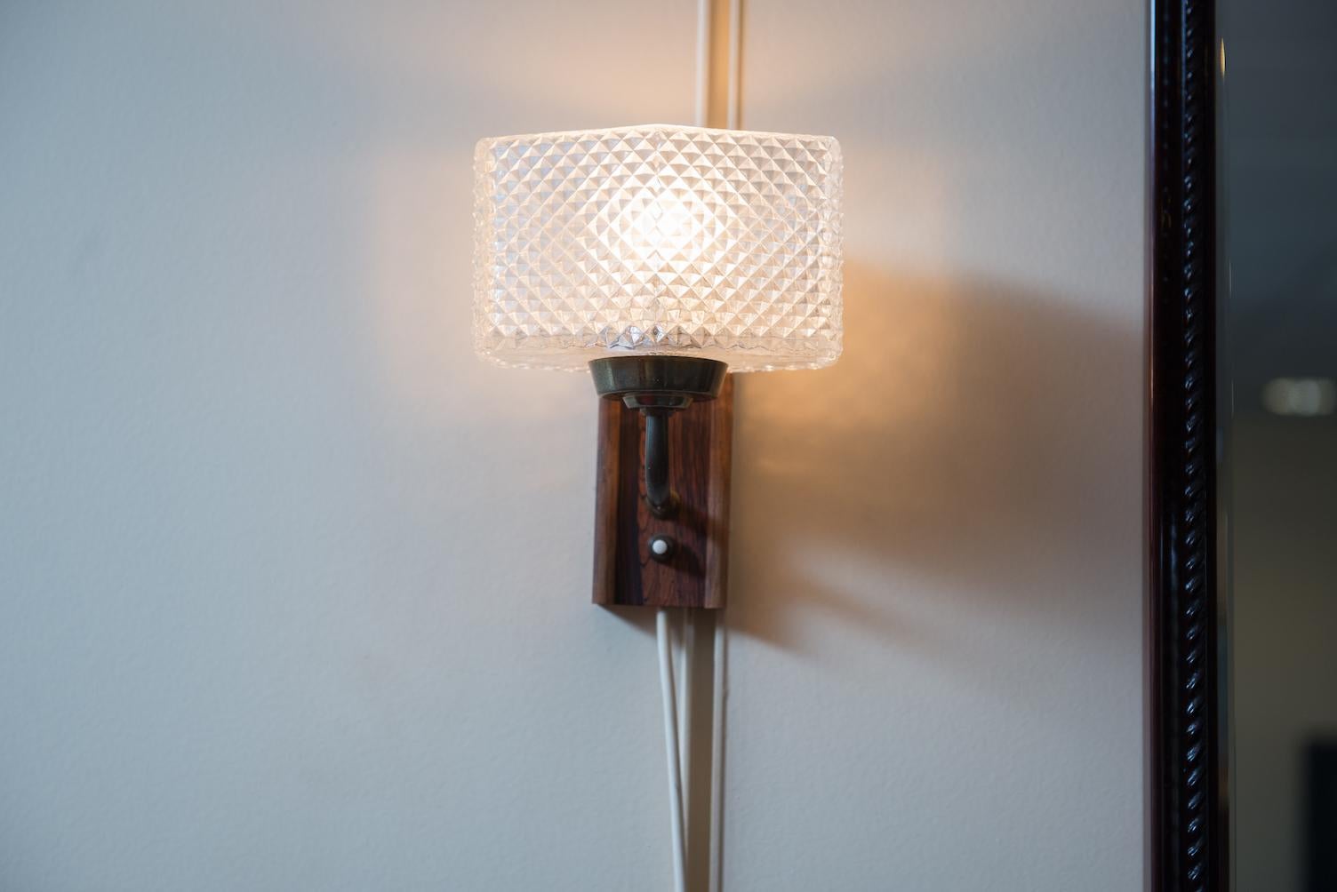 One pair of Mid-Century Modern wall sconces, wood, metal, wood imitation formica and glass.