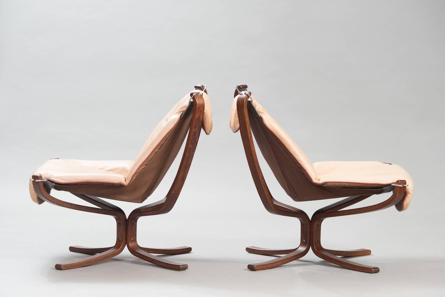 One pair of beige leather “Falcon” chairs.