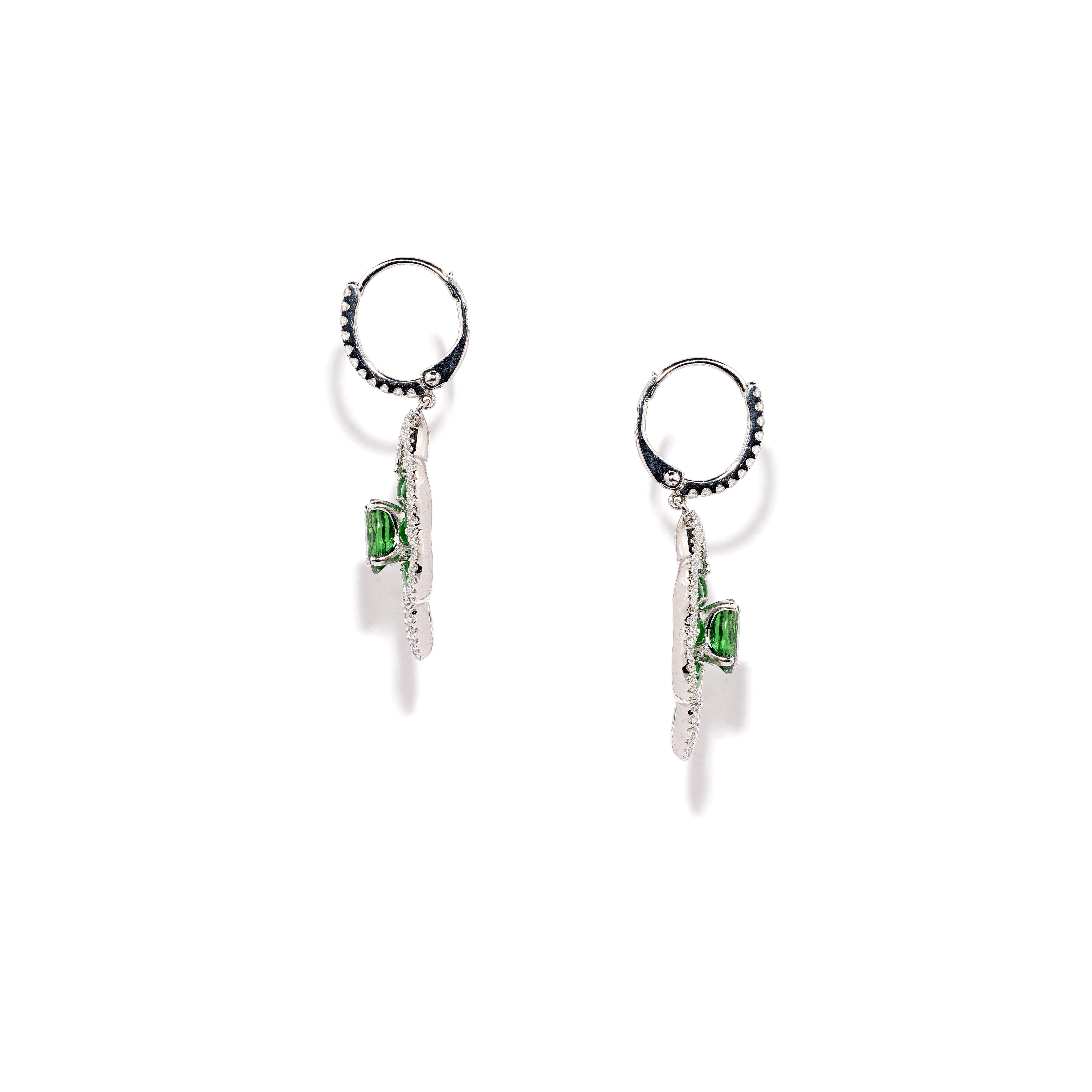 One pair of earrings made in white gold and set with:
2 Oval Shape Tsavorites weighing 2.21 cts
32 Tsavorites weighing 0.22 cts
12 Pieces of Green Jade weighing 1.59 cts
130 Brilliant Cut Diamonds weighing 0.56 cts
Gold weight: 7.06 cts
Total weight